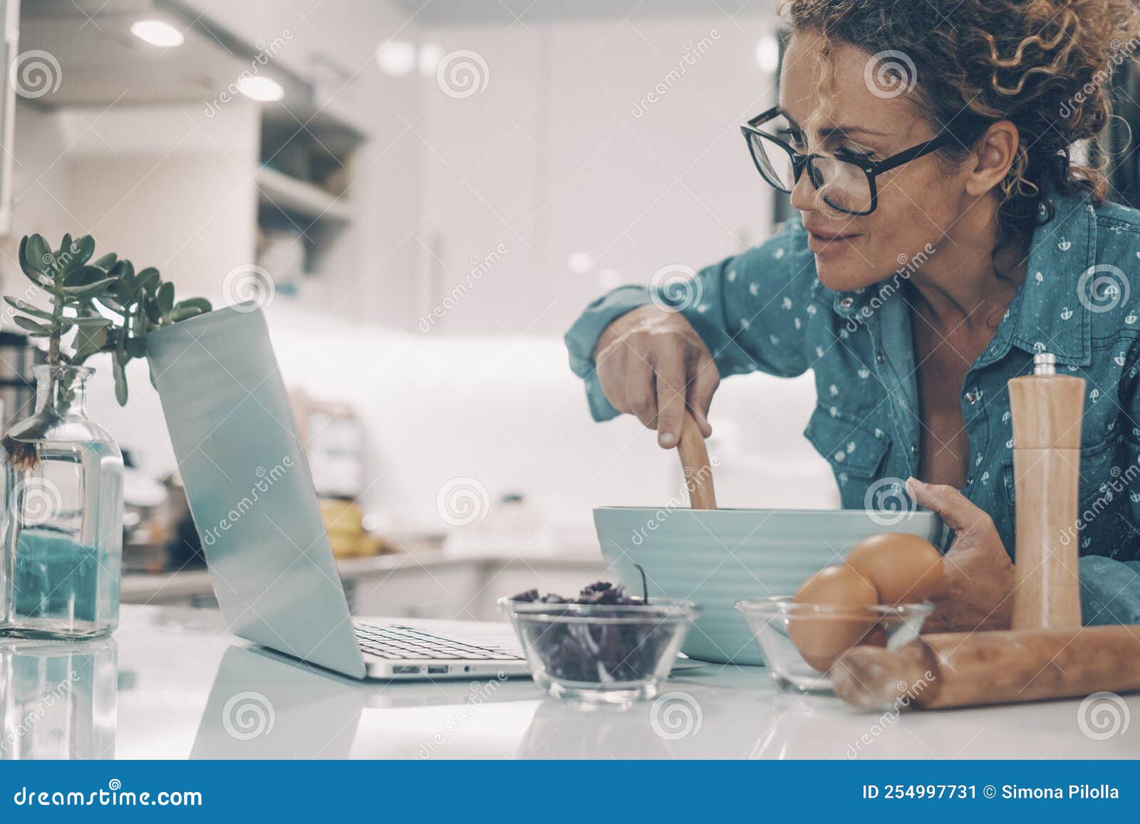 Modern Wife Prepare Breakfast or Lunch Using Computer and Online