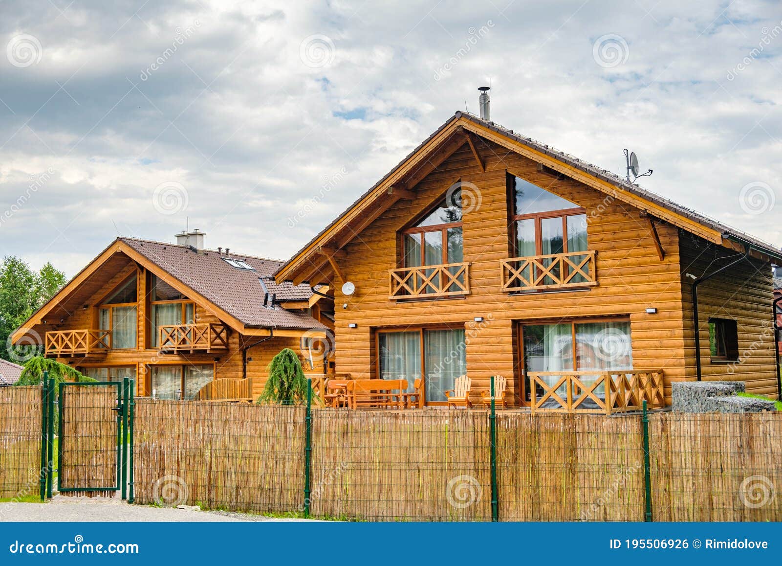 Modern Wooden House With Big Windows Surrounded By Bamboo Fence In The Suburb Building Of Houses For The Key Cottage Stock Photo Image Of Cosiness Mansion