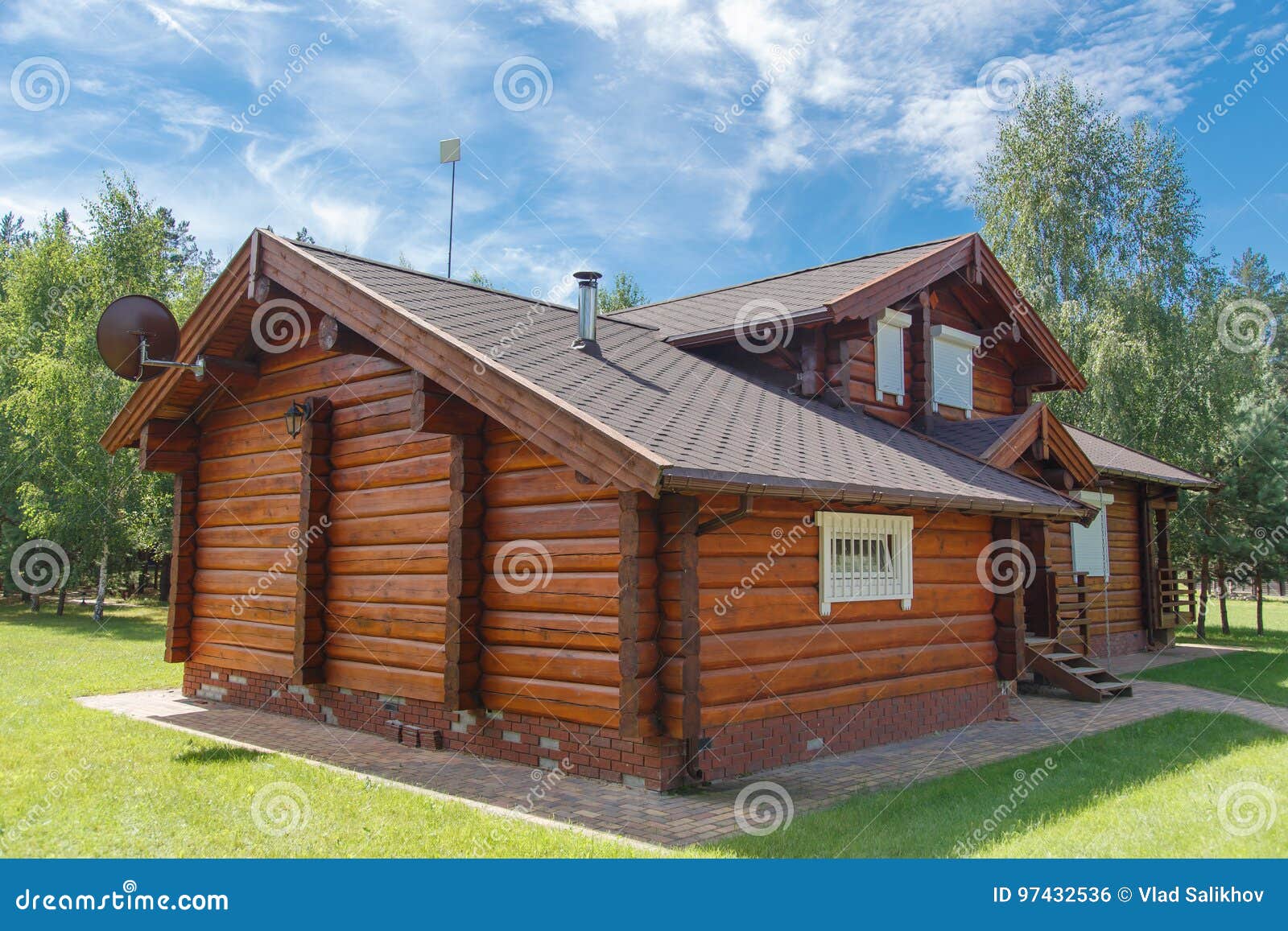 A Modern Wooden House Made Of Logs. View From Outside In Summer Stock 