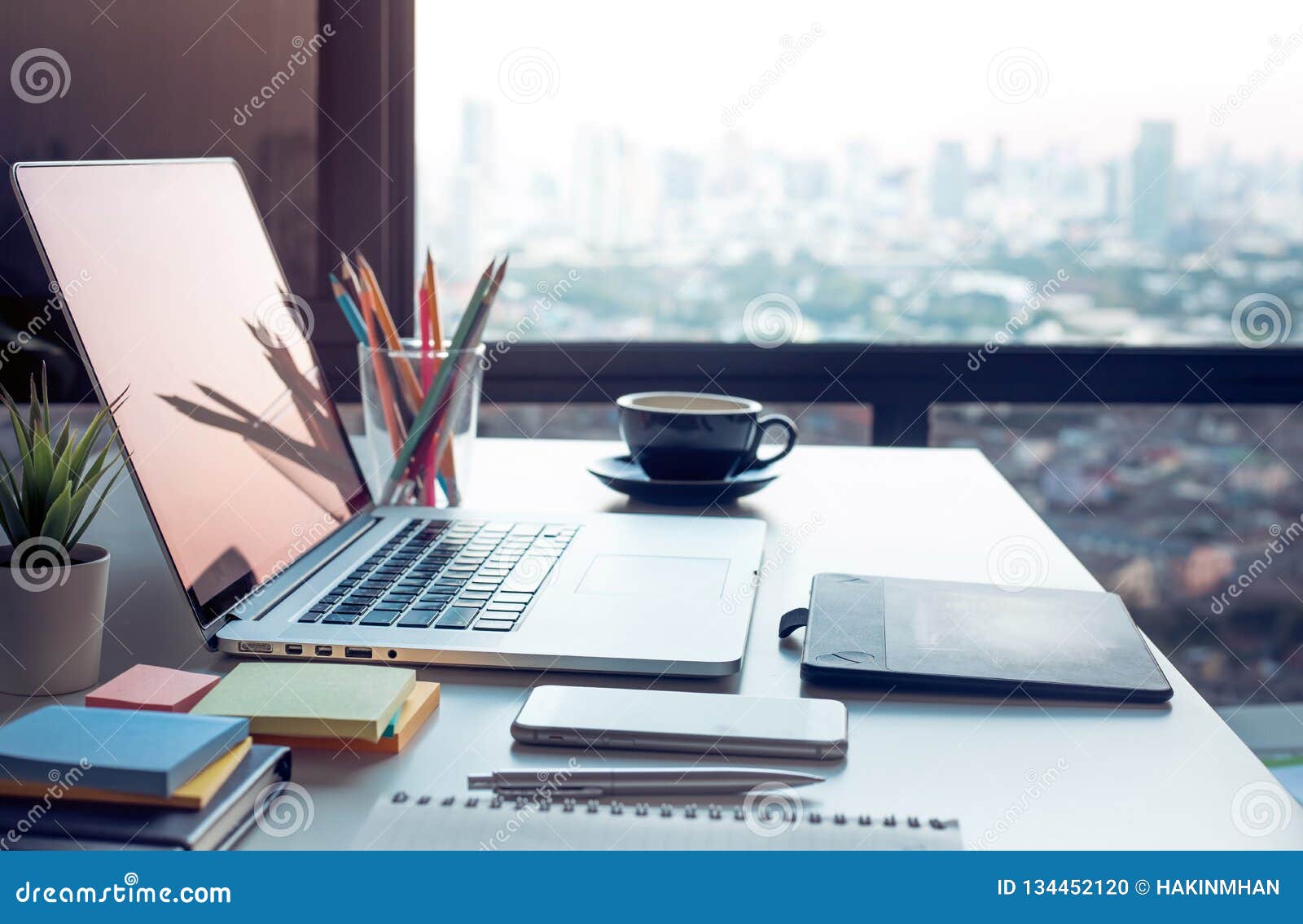 modern work table with computer laptop and cityscapes view.from window.business  ideas