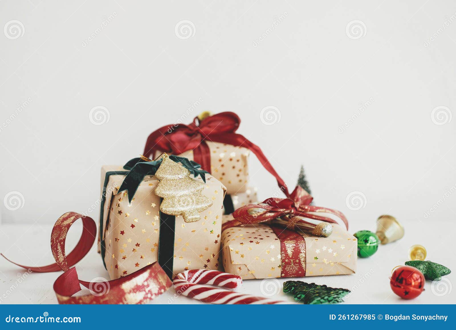 Wrapping christmas gift. Stylish festive wrapping paper, scissors, ribbons  Stock Photo by Sonyachny