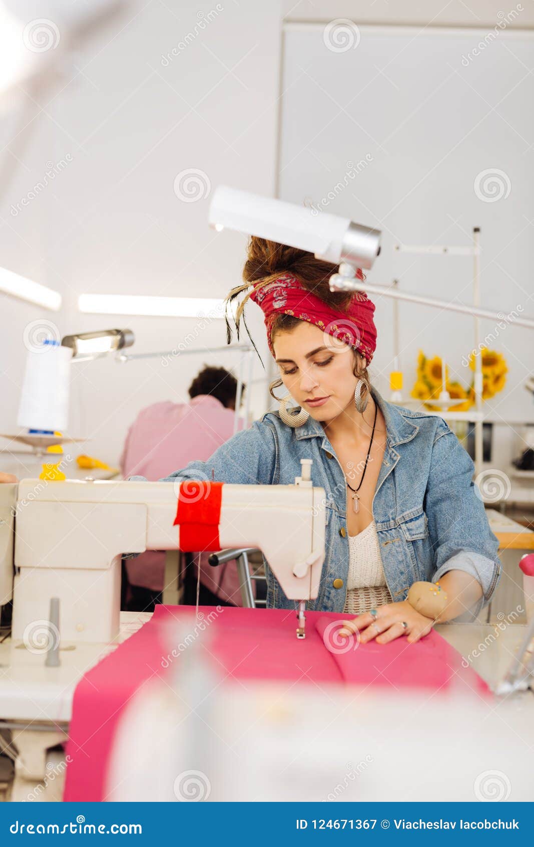 Máquina de coser profesional la costurera está en su oficina con ropa  diferente