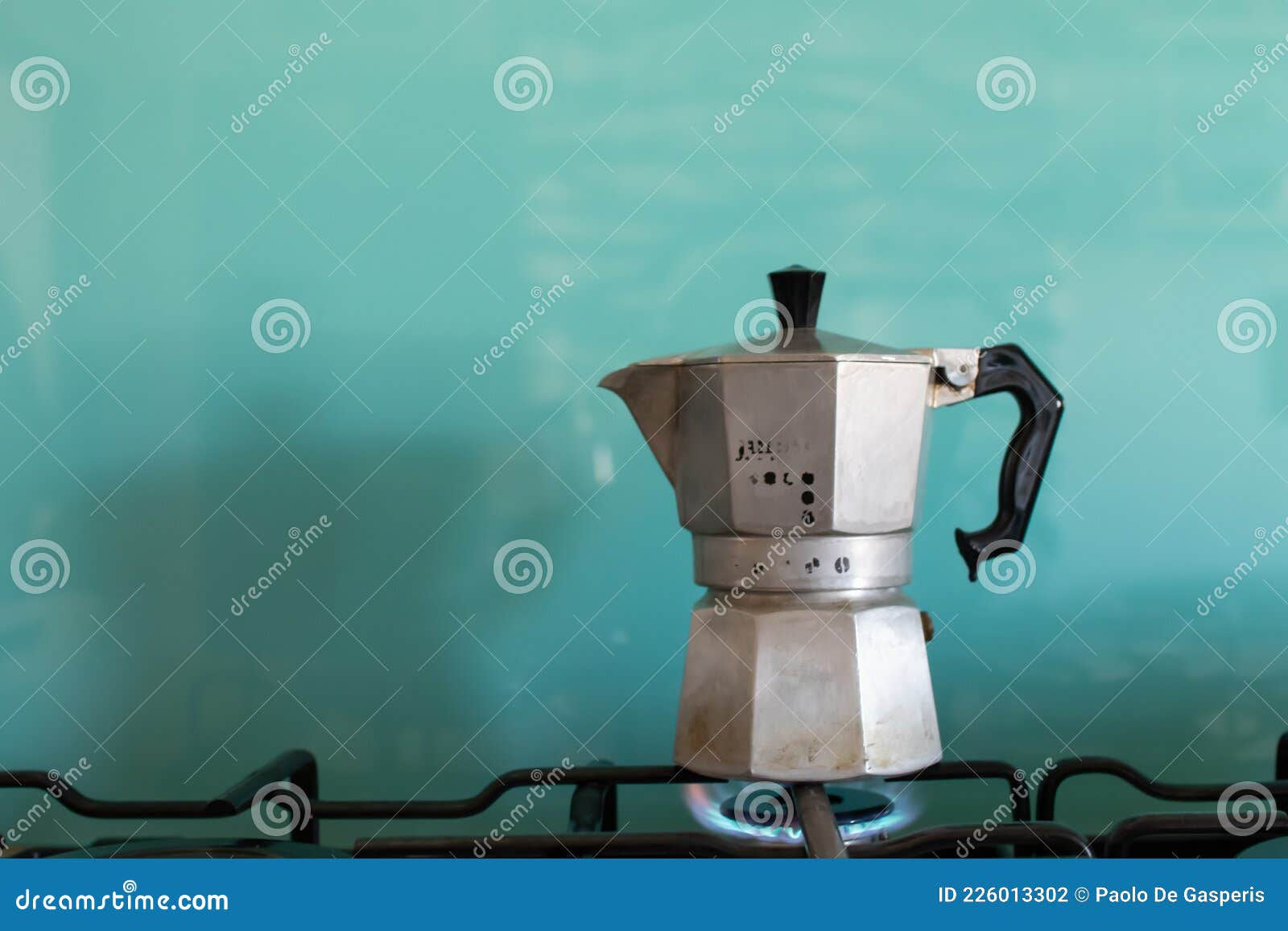 moka coffe on gas flame. italian typical coffee tool. espresso coffe with light blue background and copy space