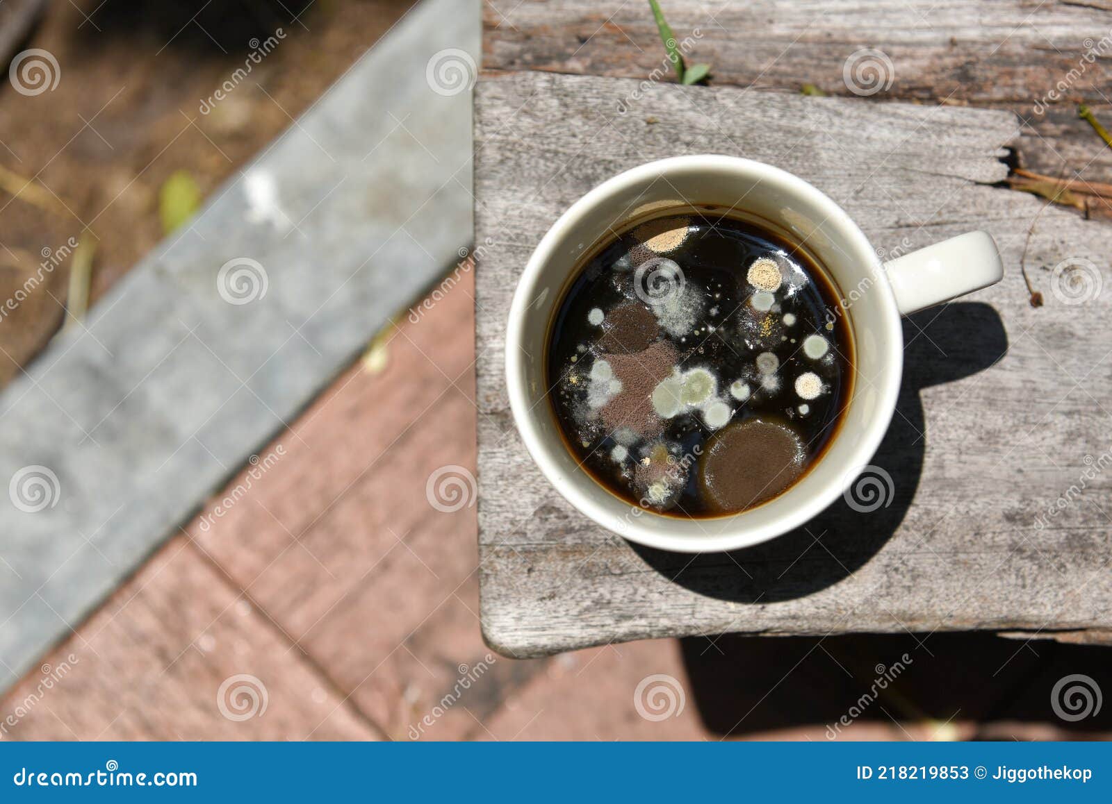 Mold in the Unwashed Cup after Cup of Coffee on Grungy Wooden