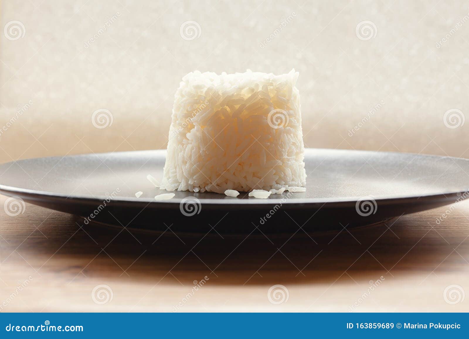 Molded Serving of Cooked Basmati White Rice on a Elegant Black Plate