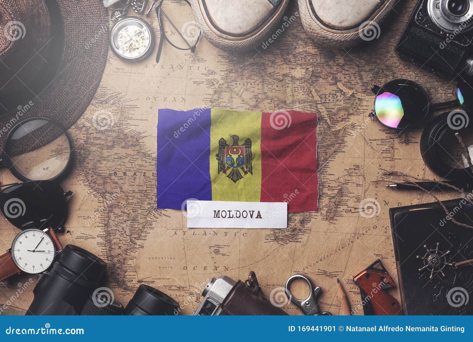 moldova flag between traveler`s accessories on old vintage map. overhead shot