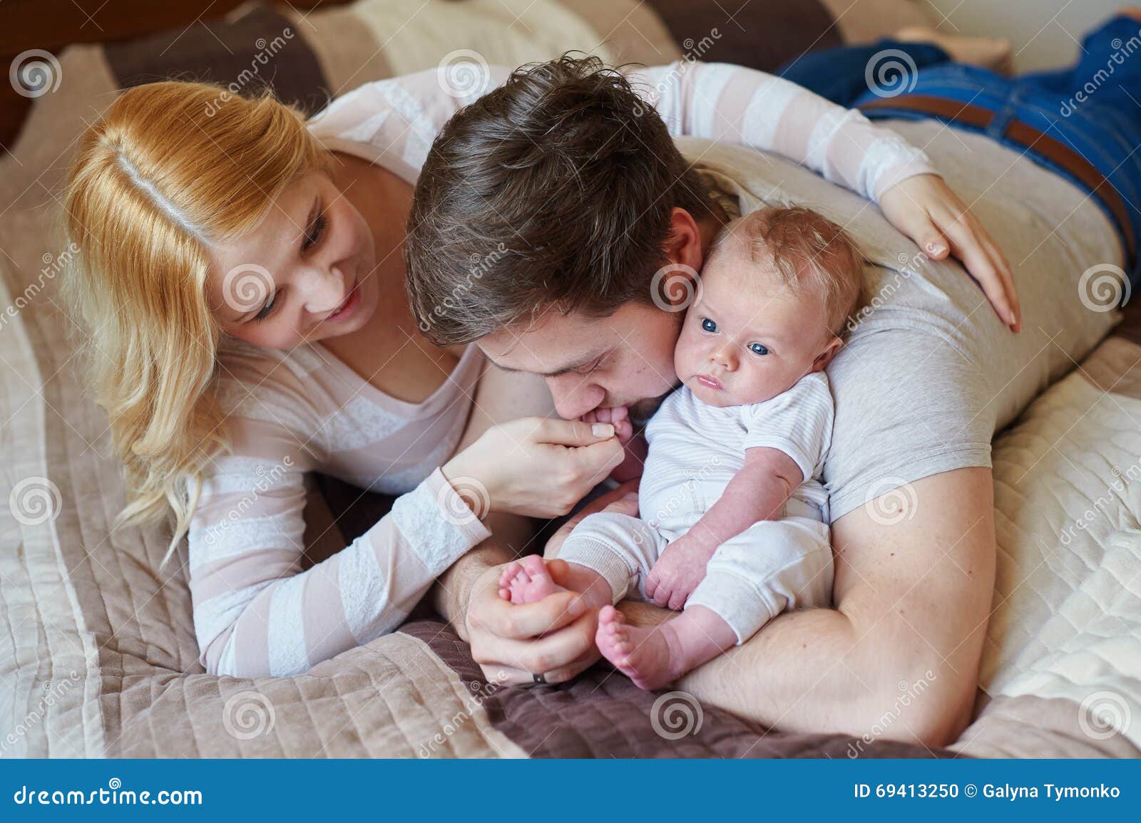 Mom and Dad Playing with His Baby Son on the Bed. Happy Family ...