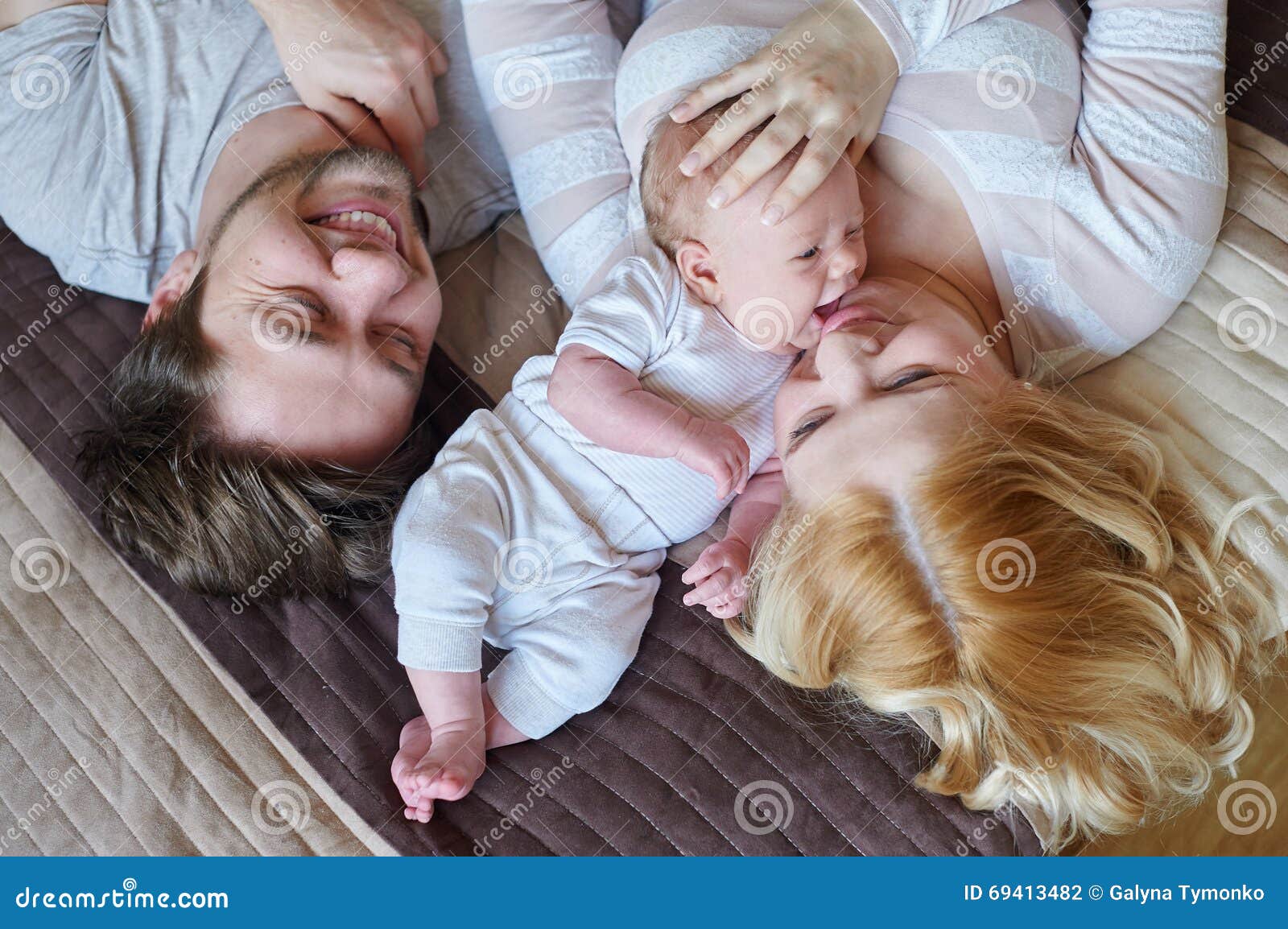 Mom and Dad Playing with His Baby Son on the Bed. Happy Family ...