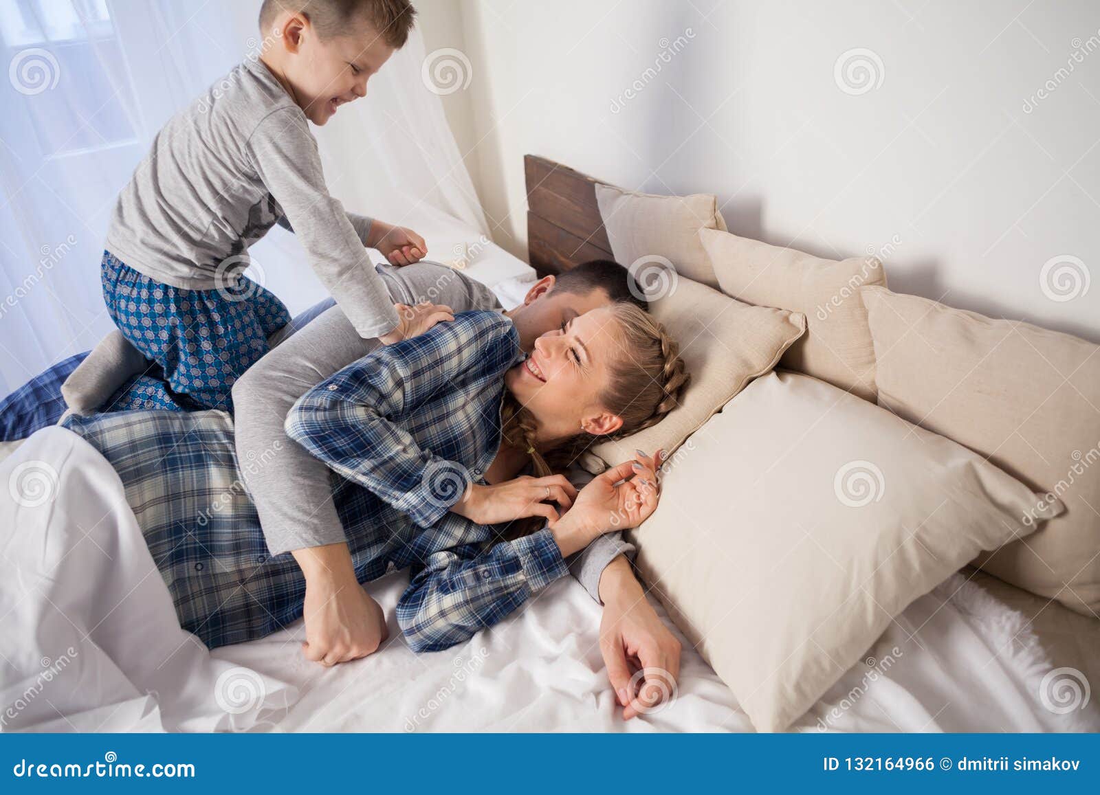Mom Dad and Young Son in the Bedroom after Sleeping House Stock Photo image