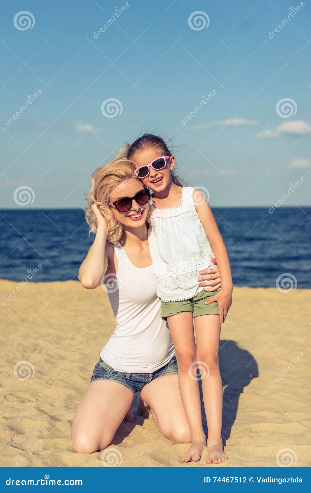 Mom And Daughter On The Beach Stock Photo - Image of life, ocean: 74467512