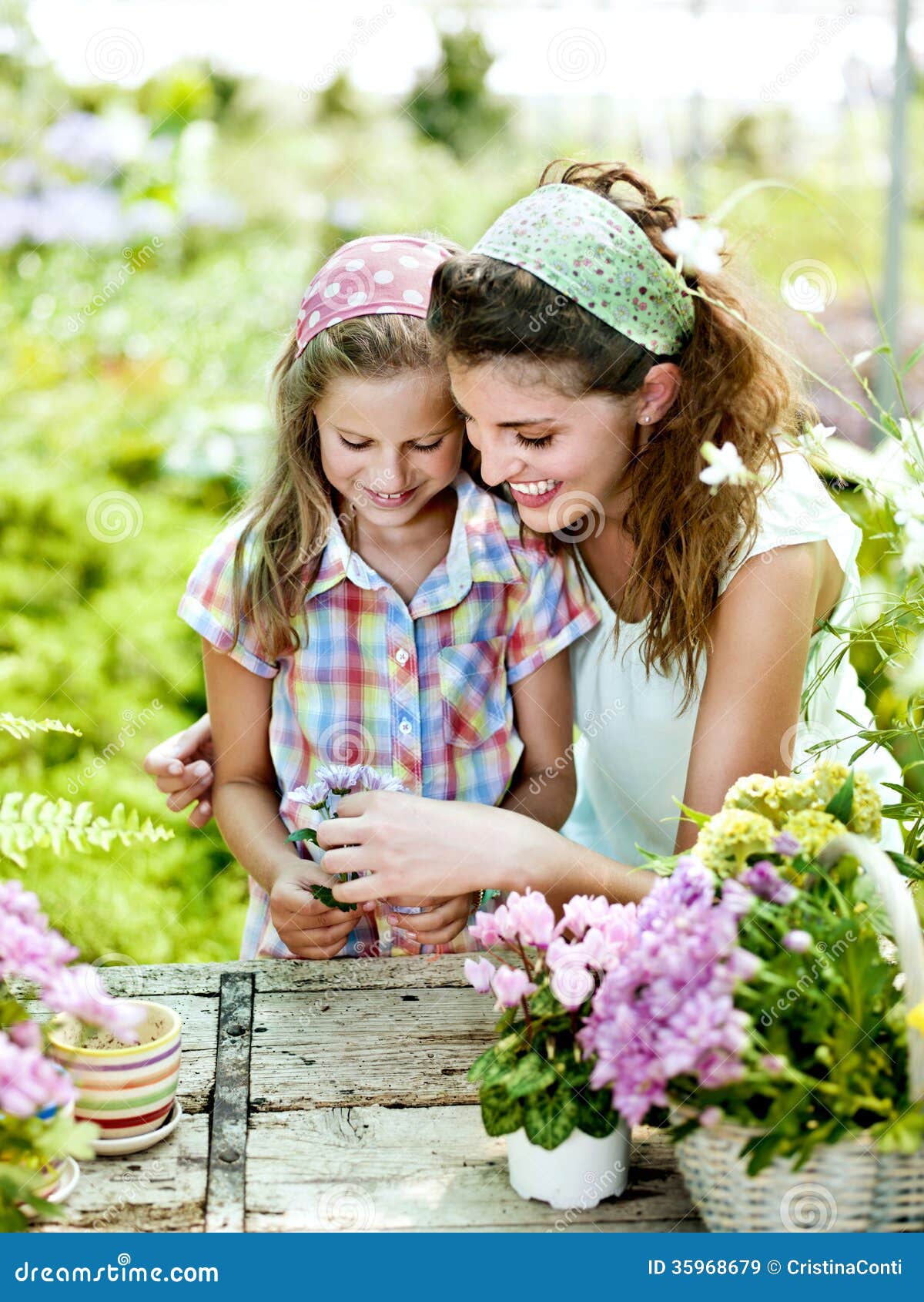 Mom And Daughter Have Fun In The Work Of Gardening Stock Image - Image