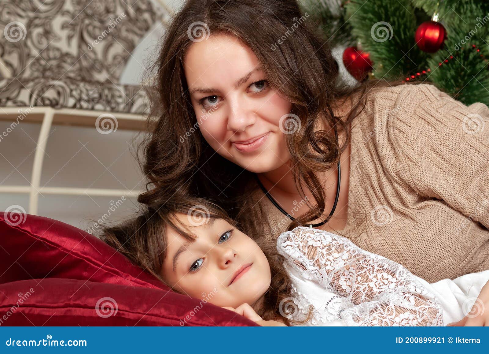 Mom And Daughter Lie On Pillows Under Christmas Tree Stock Image Image Of Decoration Happy