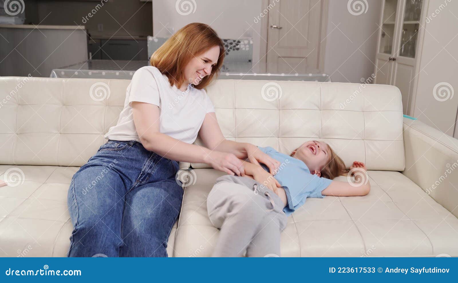 Family, video game and online gaming on home sofa with a pregnant mother  and daughter on a living room couch together while happy and having fun.  Woman and girl kid together for