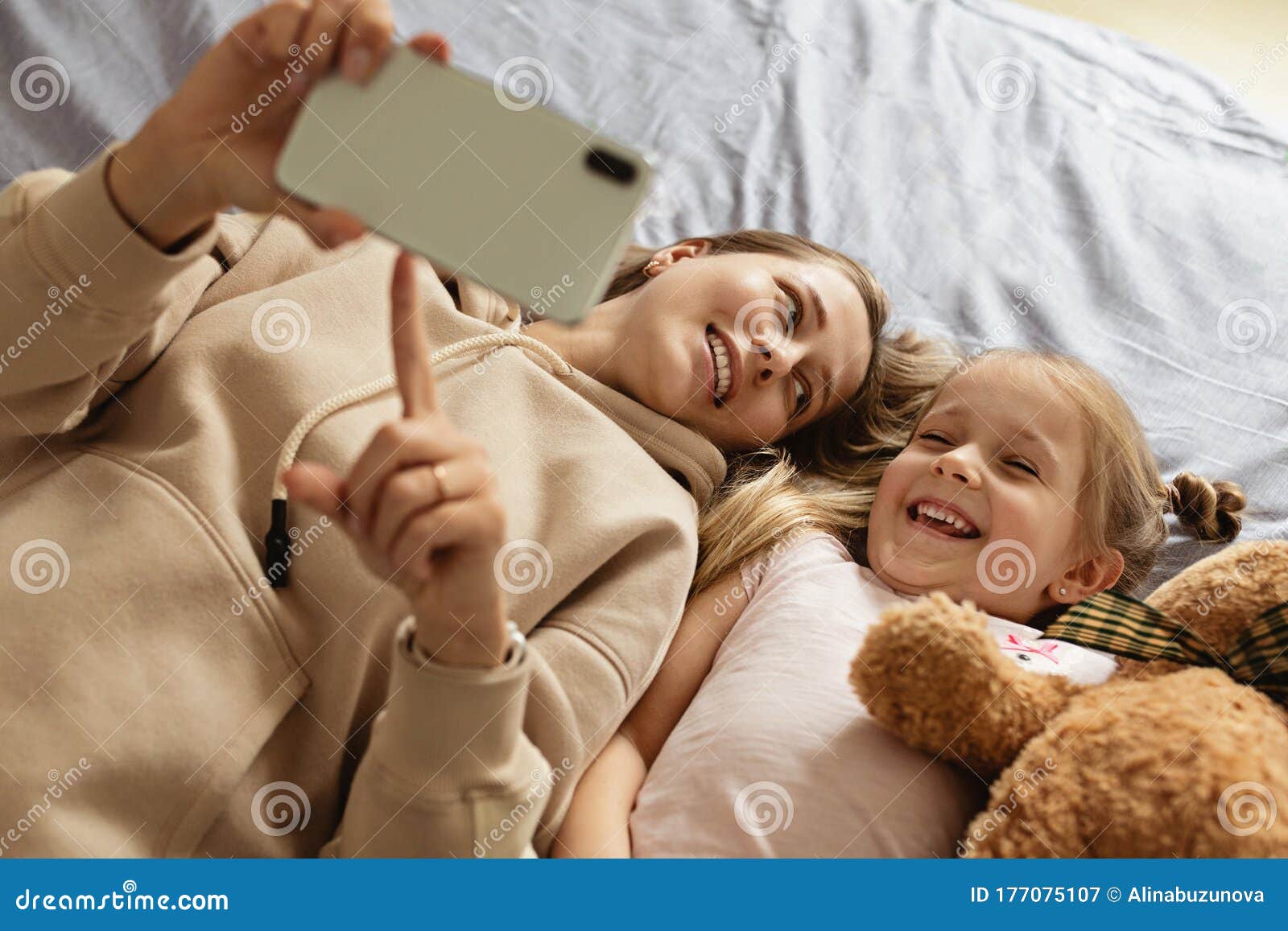 Mom and Daughter Watching Video on Smartphone with Smiley Face Alone on ...