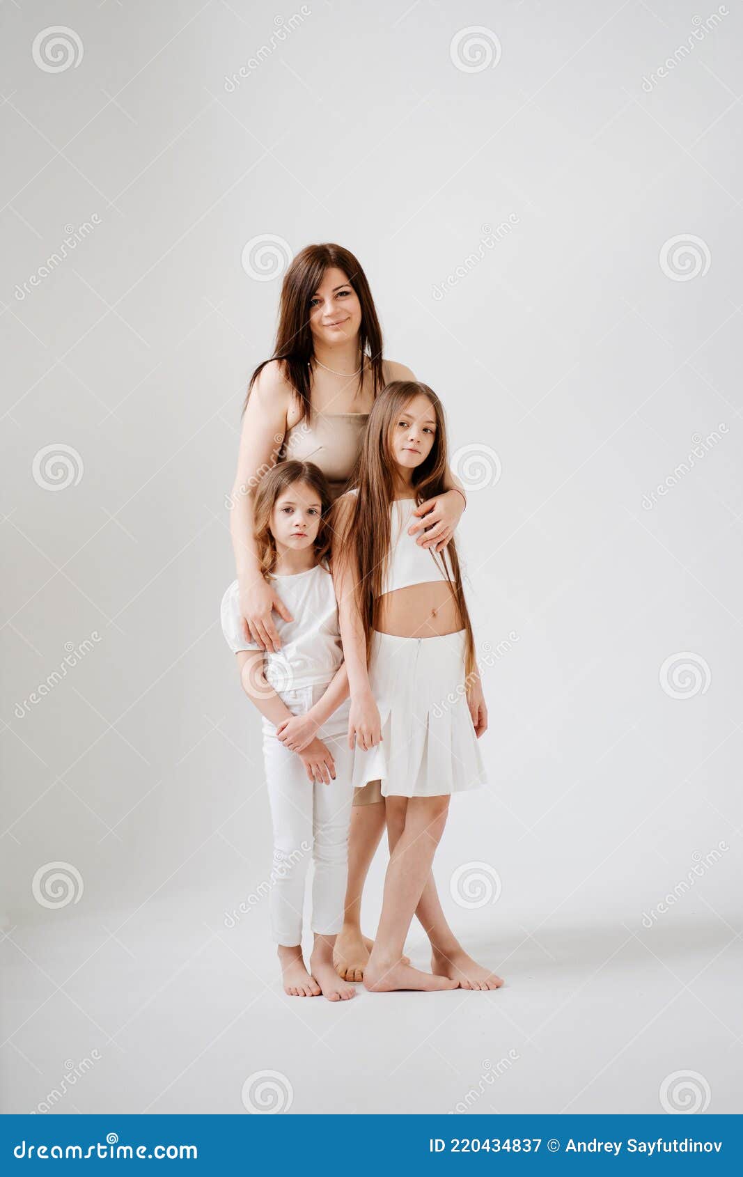 Indoor Portrait Of A Beautiful Mother With Her Charming Little Daughter  Posing Against Bedroom Interior. Stock Photo, Picture and Royalty Free  Image. Image 128585994.