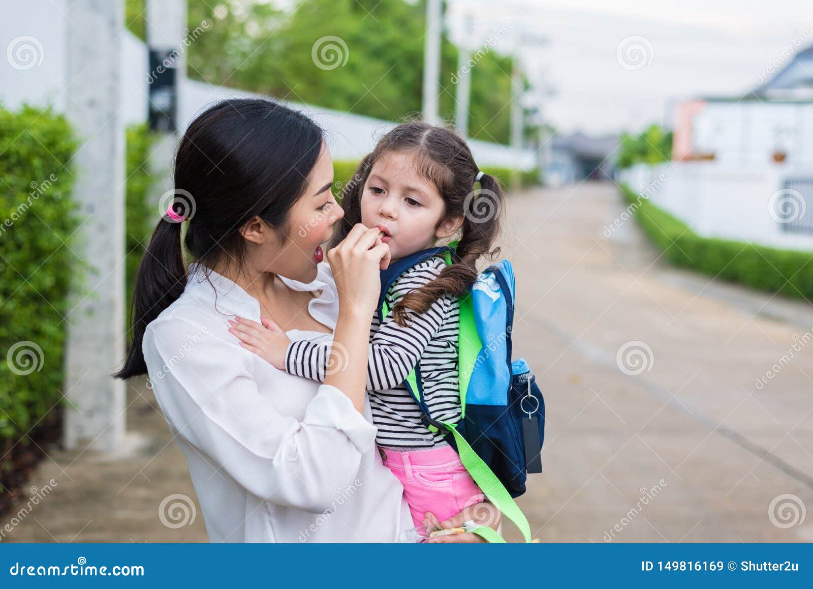 Mom Feeding Her Daughter With Snack Before Going To School B