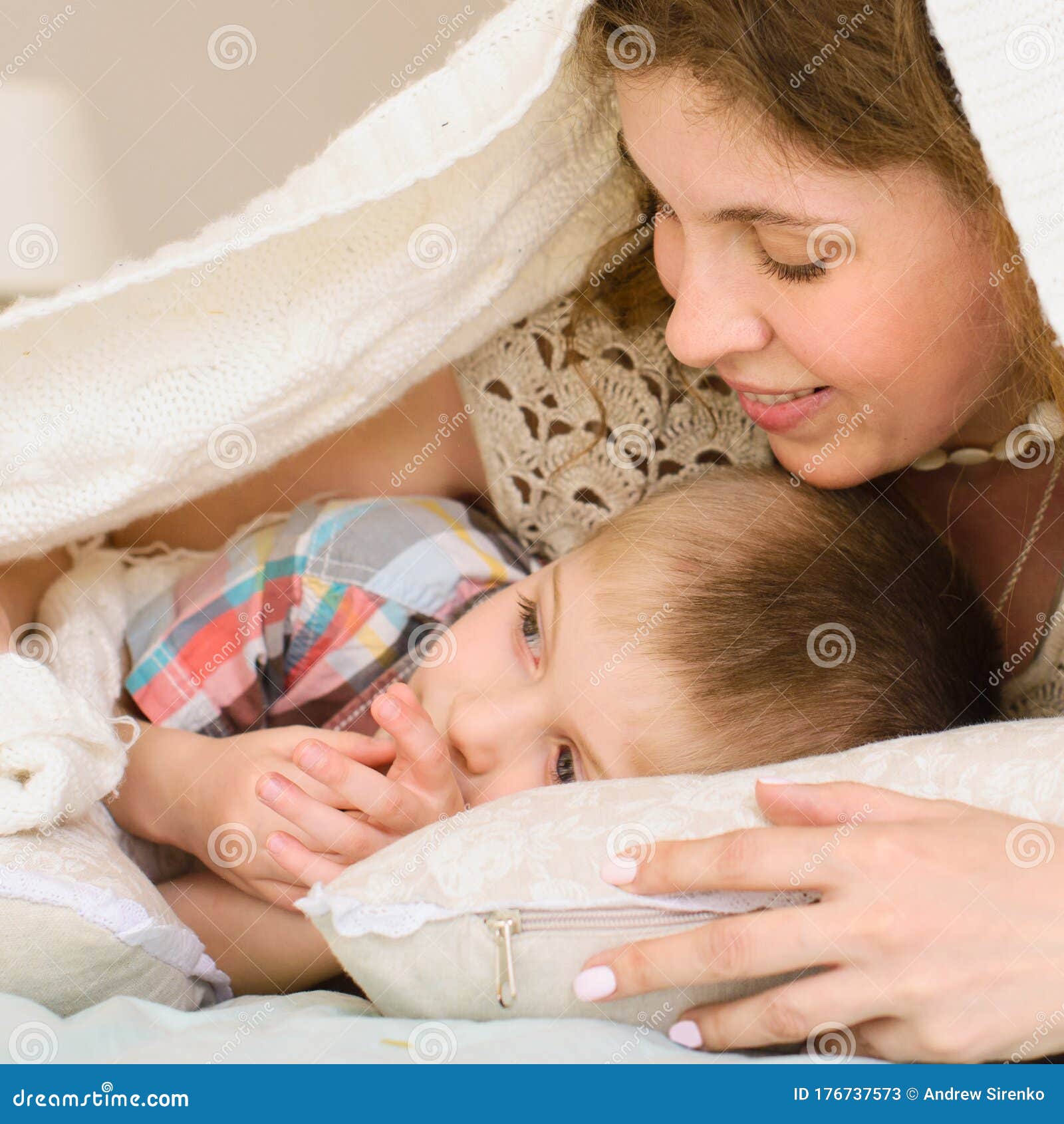 Mom Gently Looks At Her Son They Lying On Bed