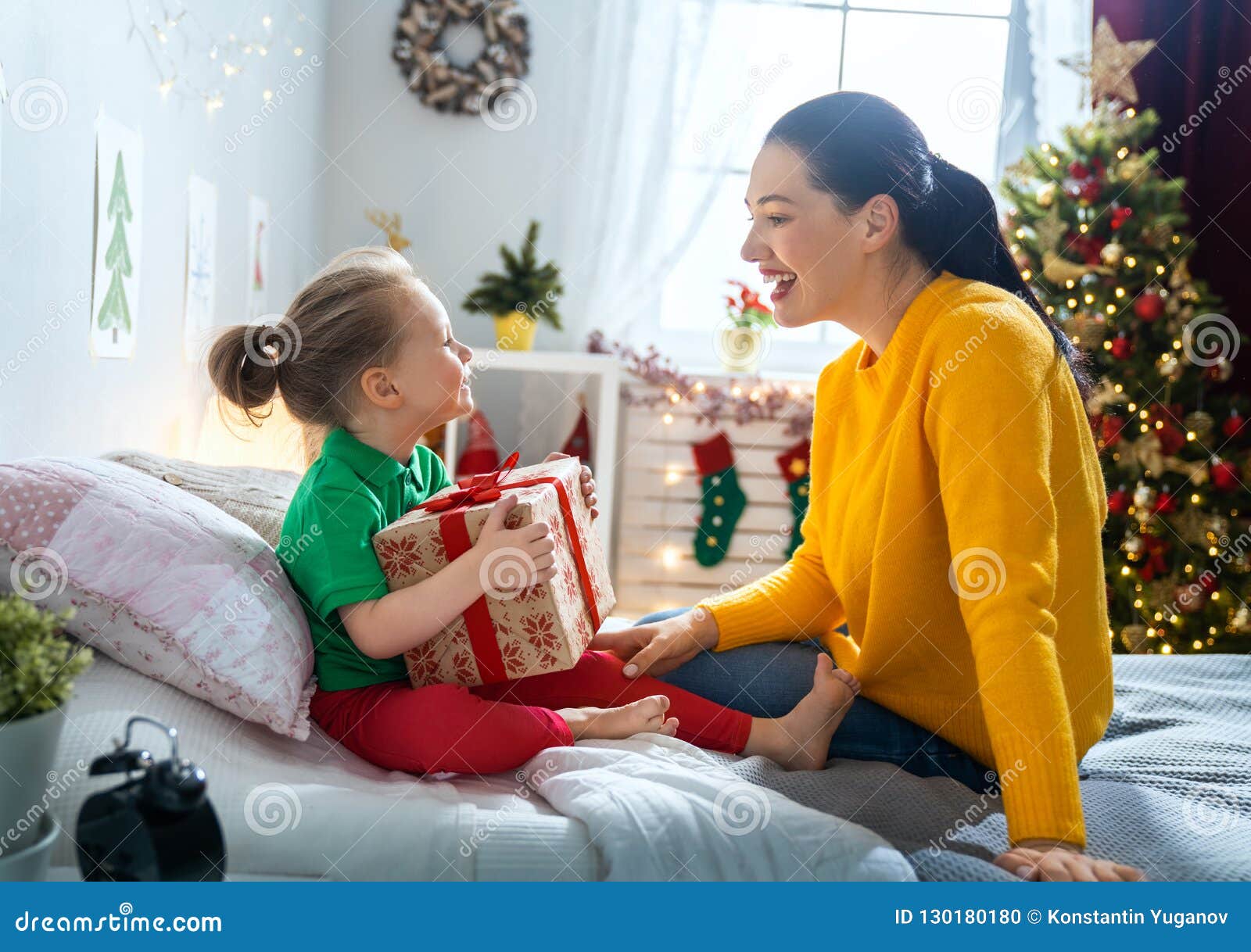 https://thumbs.dreamstime.com/z/mom-giving-gift-to-daughter-merry-christmas-happy-holidays-cheerful-her-cute-girl-parent-little-child-near-tree-indoors-loving-130180180.jpg