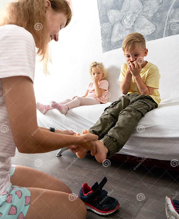 Collection 28+ Stock Photos mom helps the little boy take off socks Stunning