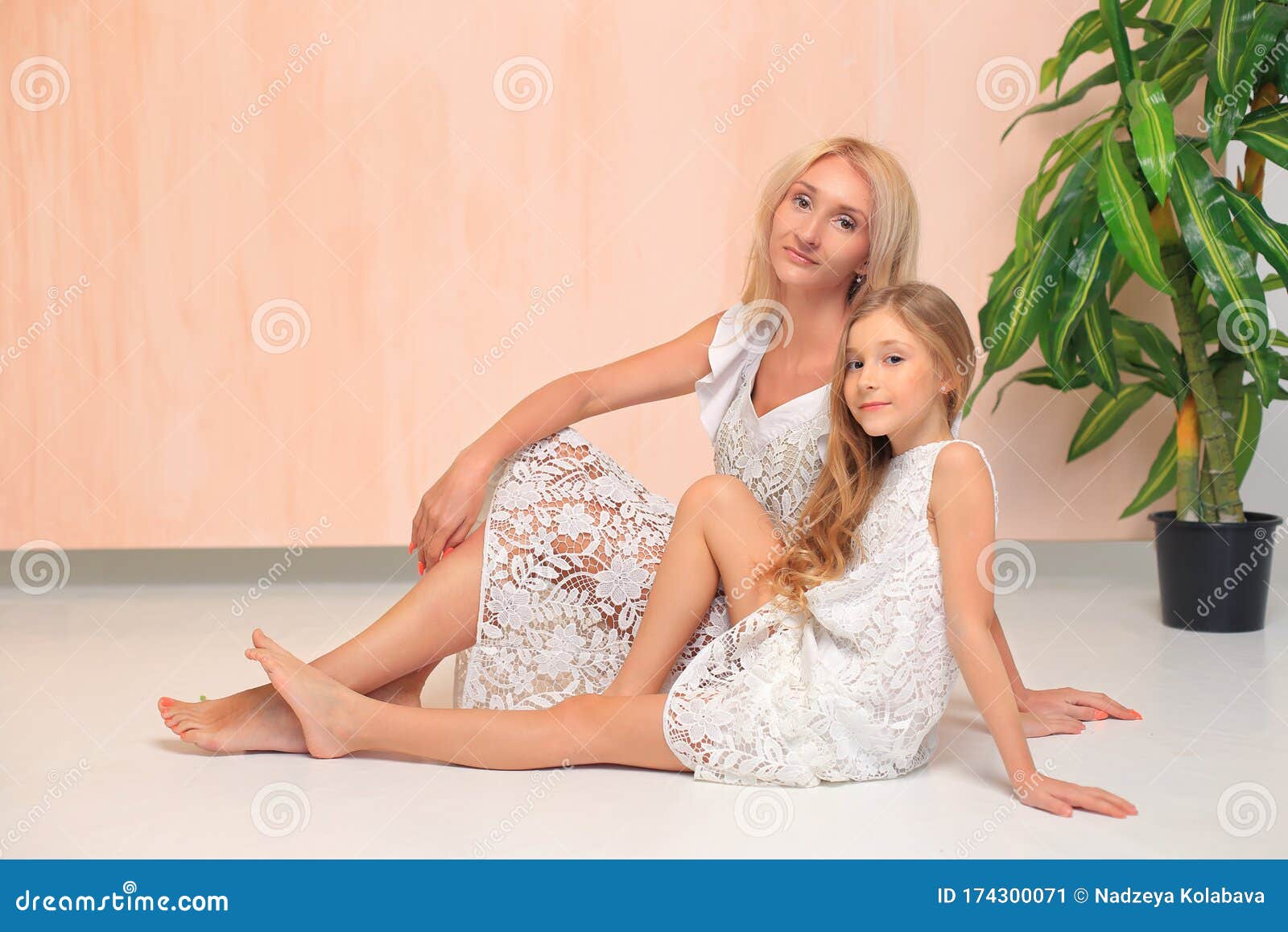 Mom With Her Daughter In White Dresses In The Studio Stock I