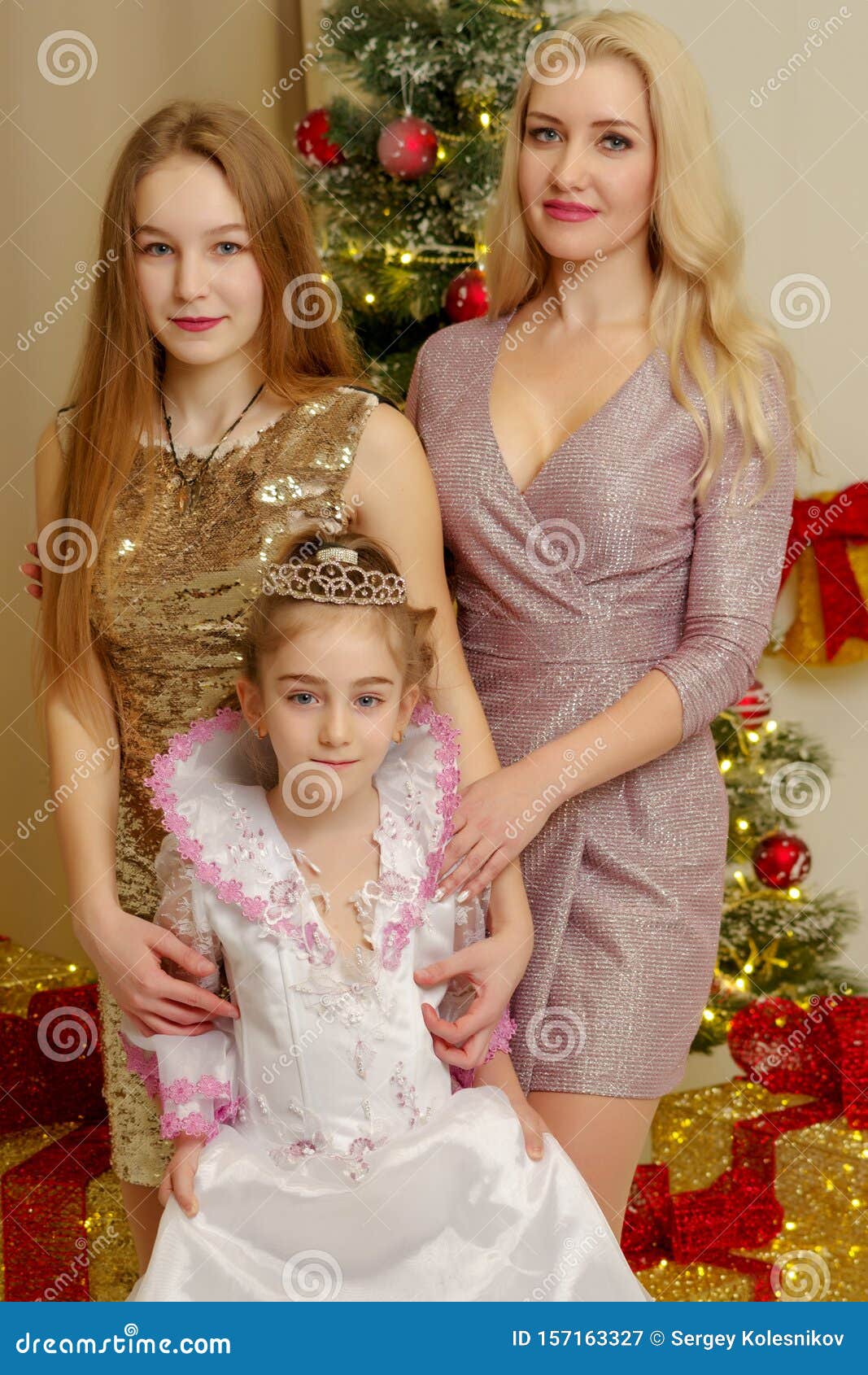 Mom with Her Daughters Near the New Year Tree. Stock Image - Image of ...