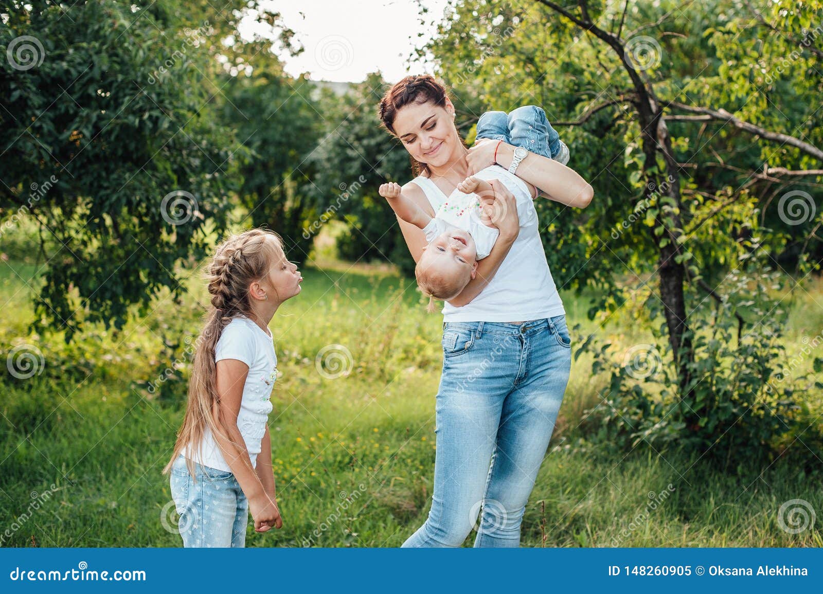 Mom And Her Daughters Are Walking In The Summer Park Stock Image 