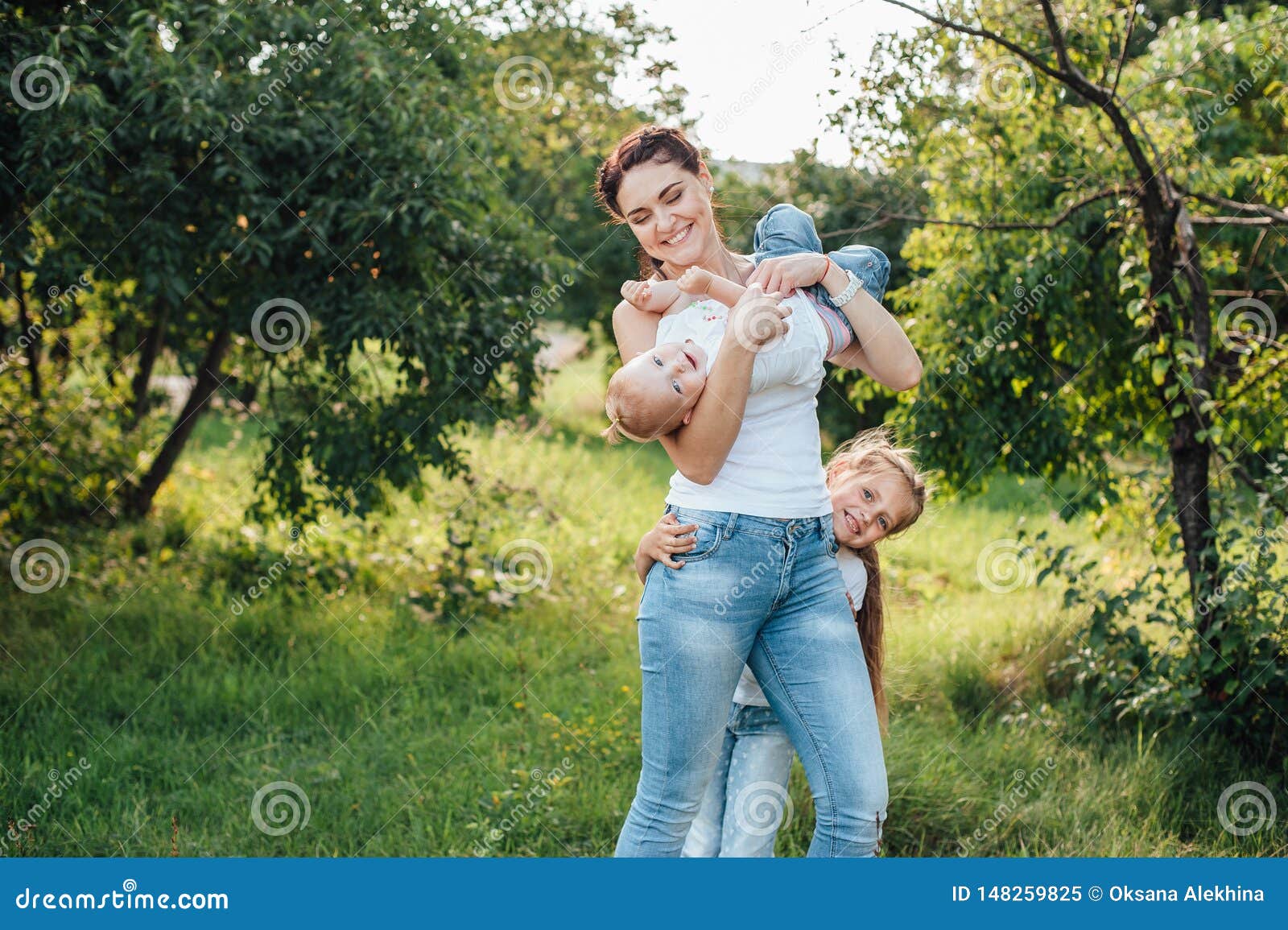 Mom And Her Daughters Are Walking In The Summer Park Stock Image 