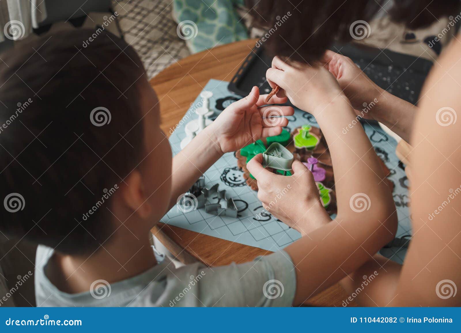 Mom and Her Son Cook Cookies in the Cozy Home Kitc image