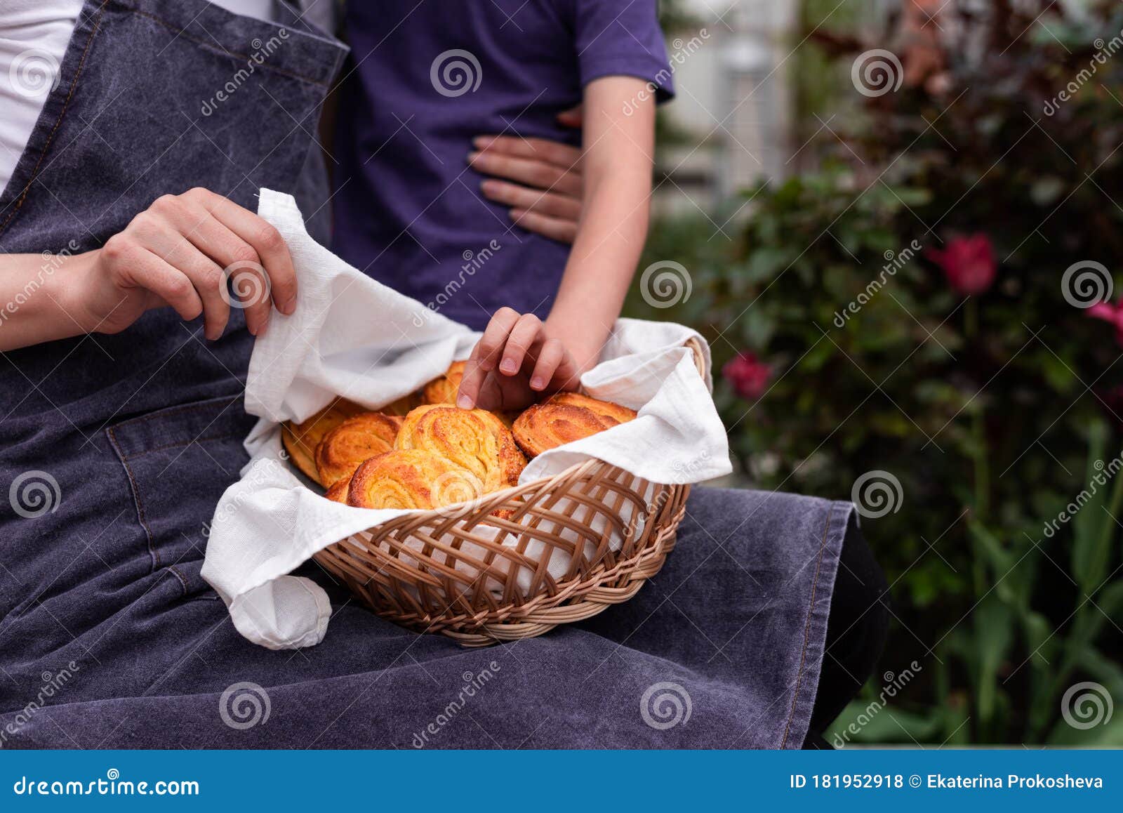 Mom with Her Son with Homemade Buns in the Garden Stock Ph image