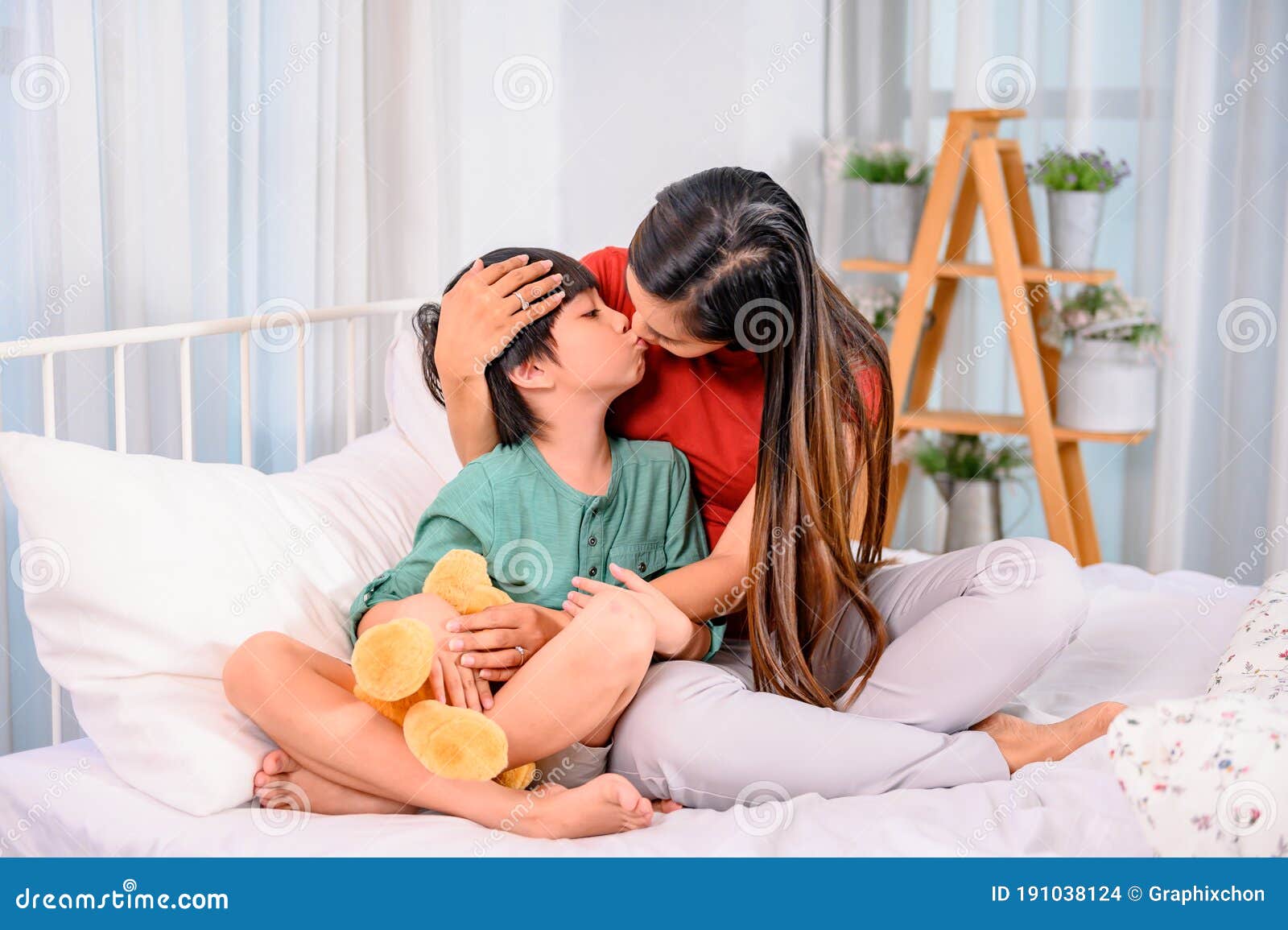 Mom Hug And Kiss Son On The Bed Woman Lifestyle And Family Activit