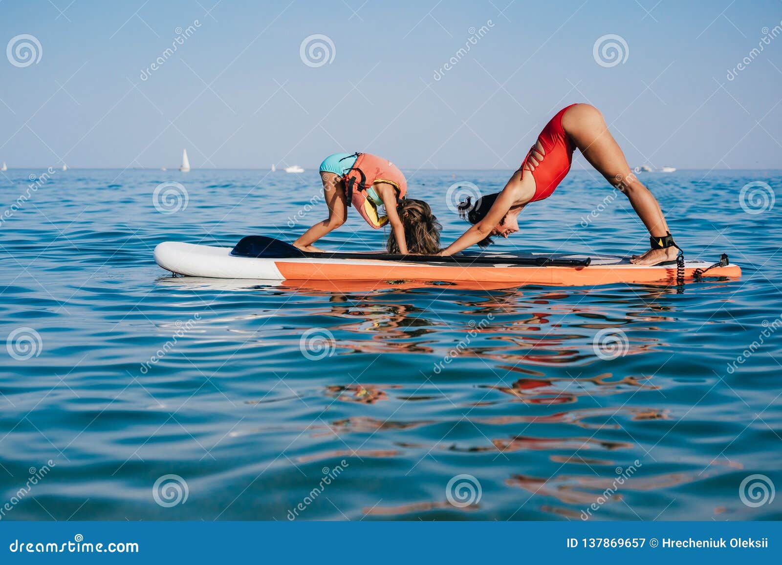 Mom and Little Daughter Doing Yoga on the Paddle Board Stock Image ...