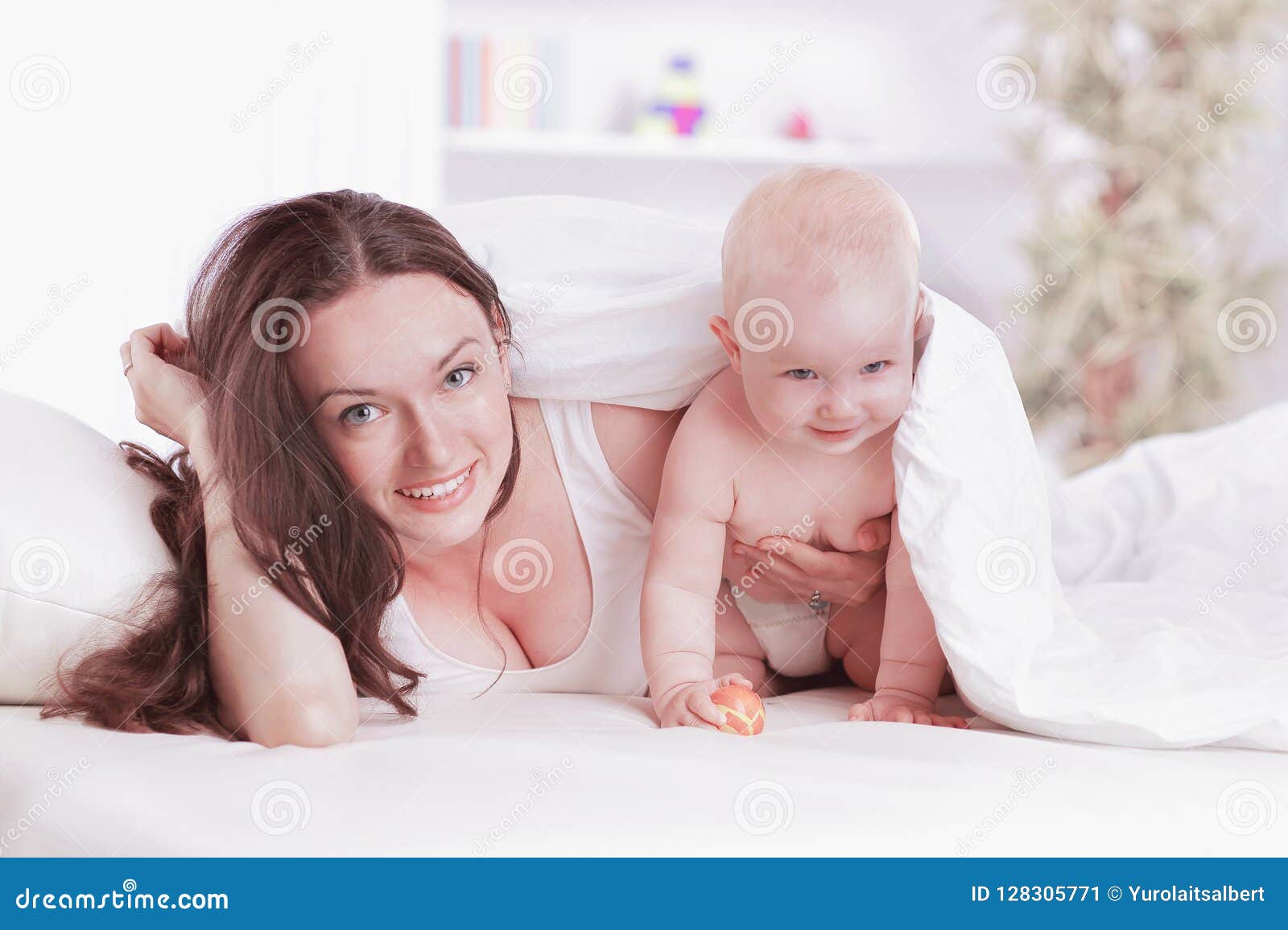 Mom Plays with the Baby Lying on the Bed Stock Image - Image of blanket ...