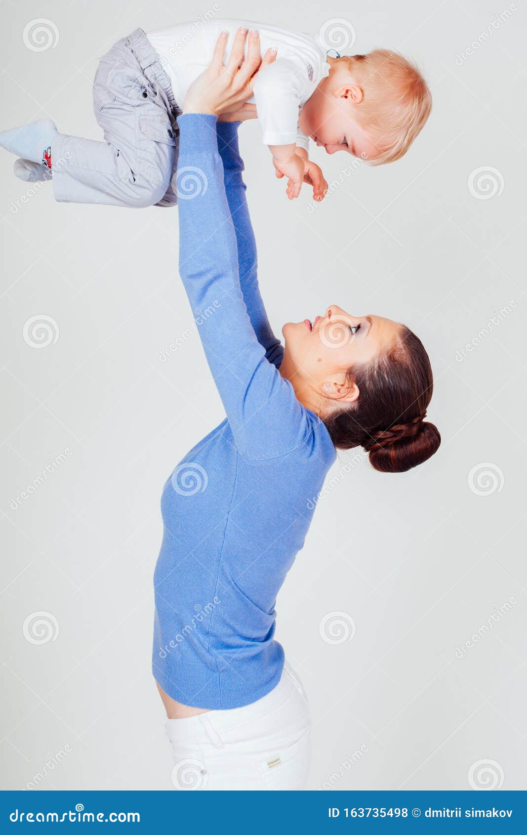 Mom Raises Her Son Hands Up White Stock Photo - Image of mother, love ...