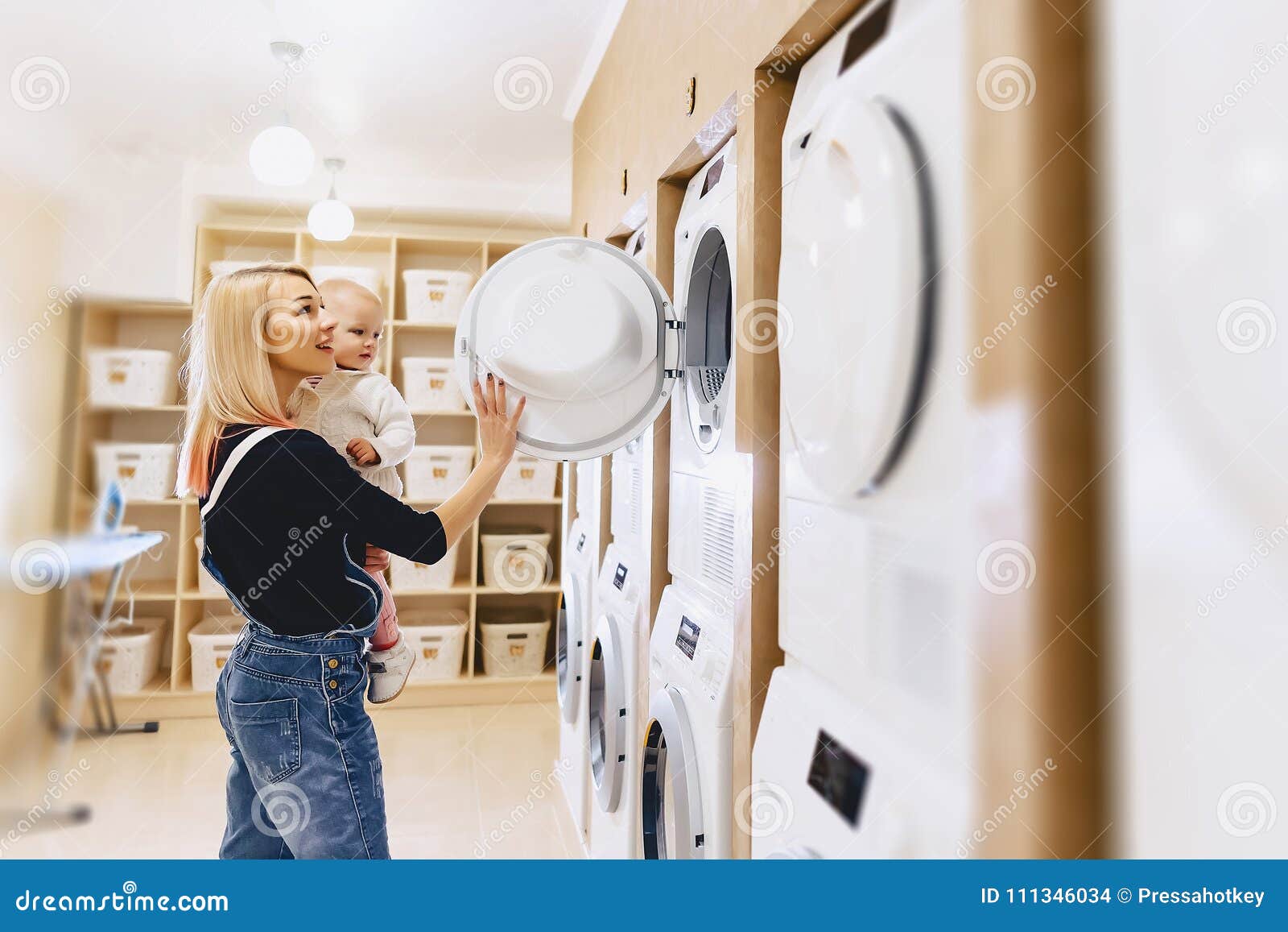 Mom Shows Her Daughter a Washing Machine Stock Photo Image of child, helping 111346034
