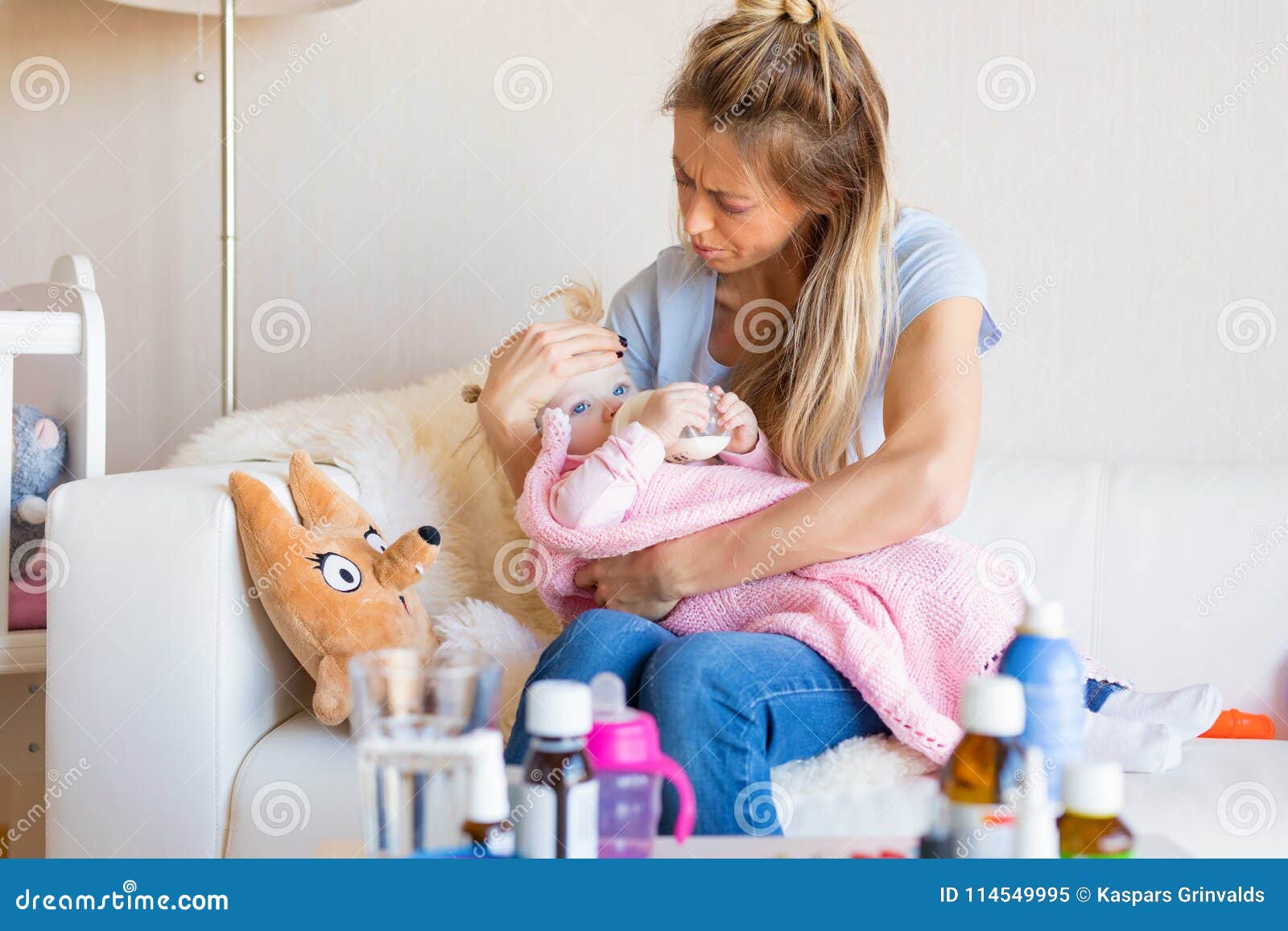 Mom with sick baby at home stock image. Image of health 114549995