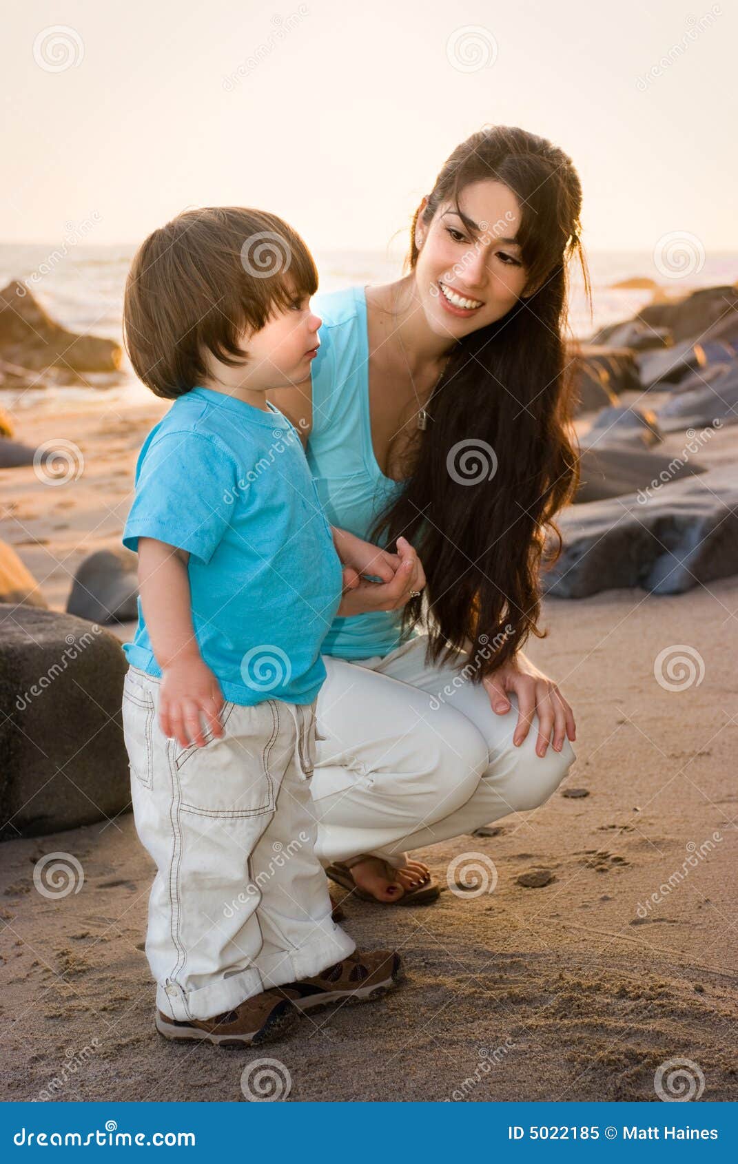 Mom and son on beach 1 stock image