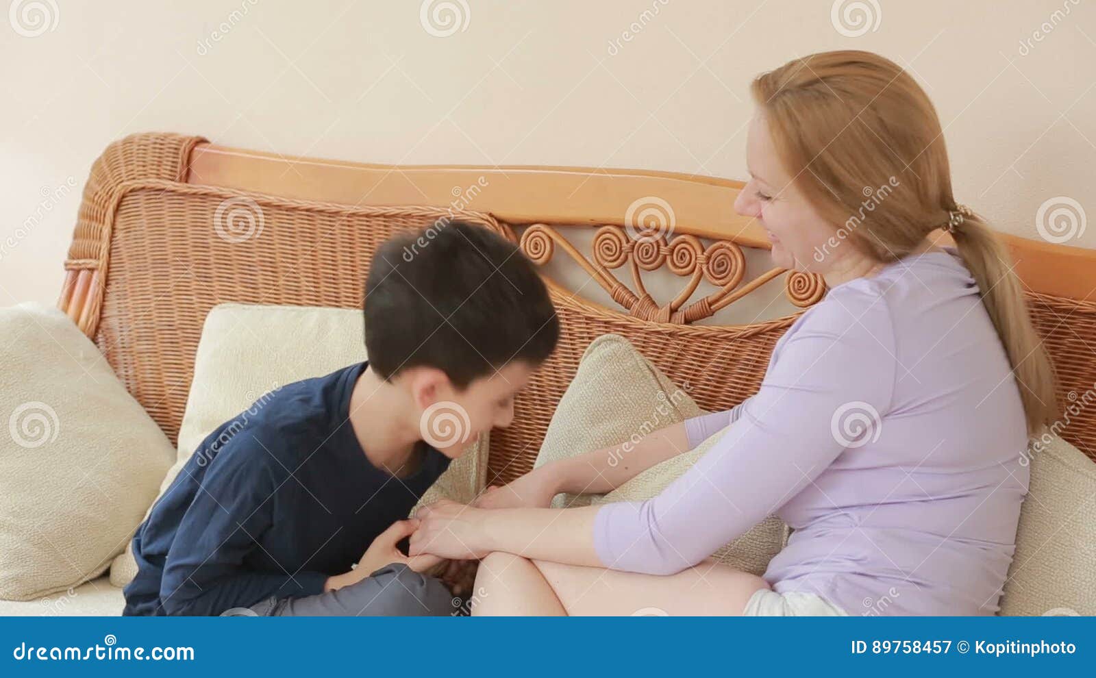 Сынок маму в очко. Mom and son chatting Heart to Heart on the Wicker Sofa stock.