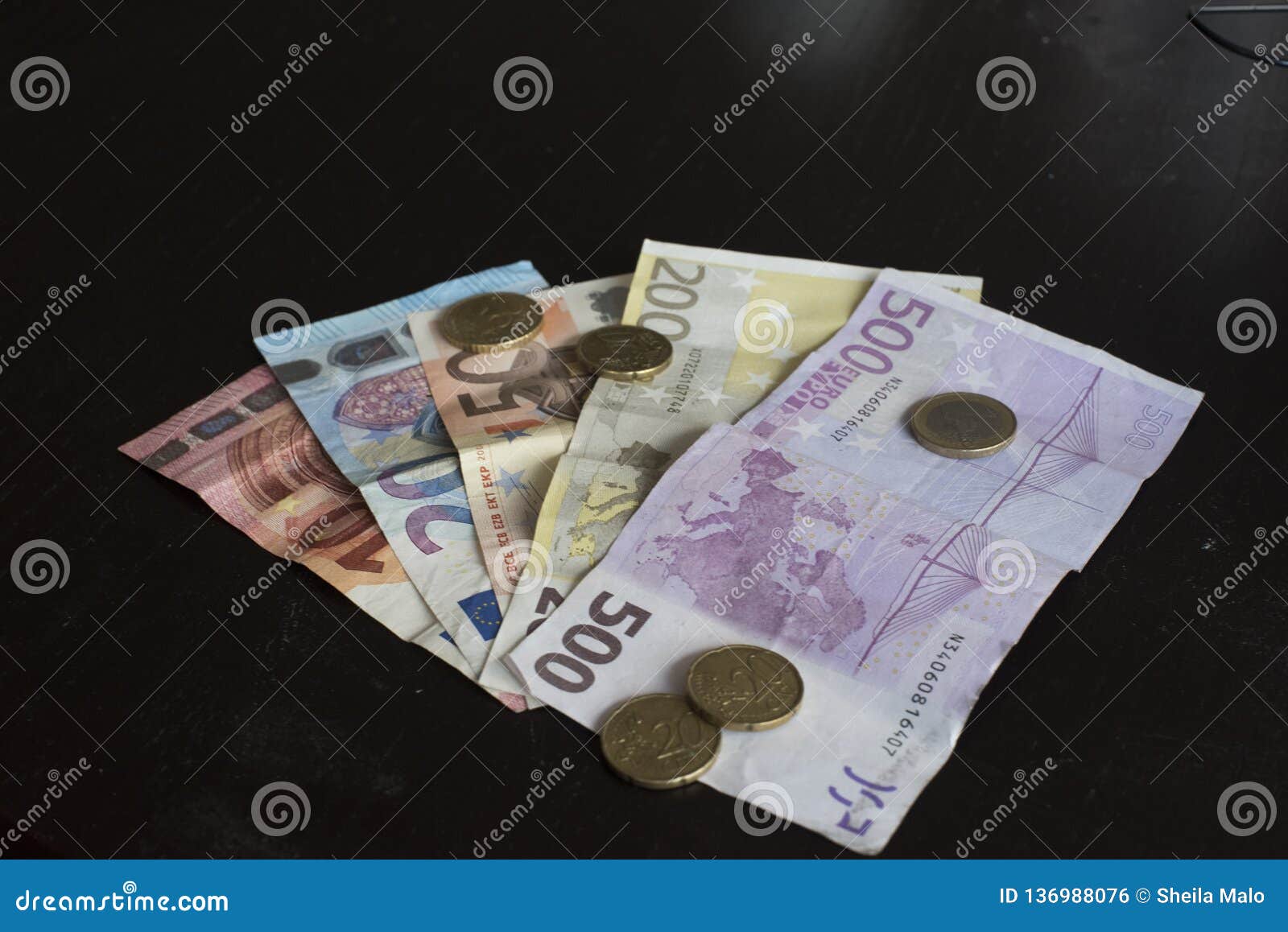 money bills and euro coins on a table