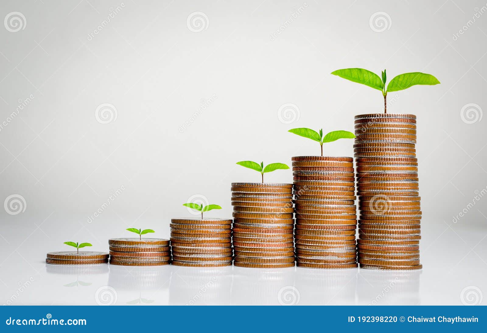 money coin stack growing graph on gray background