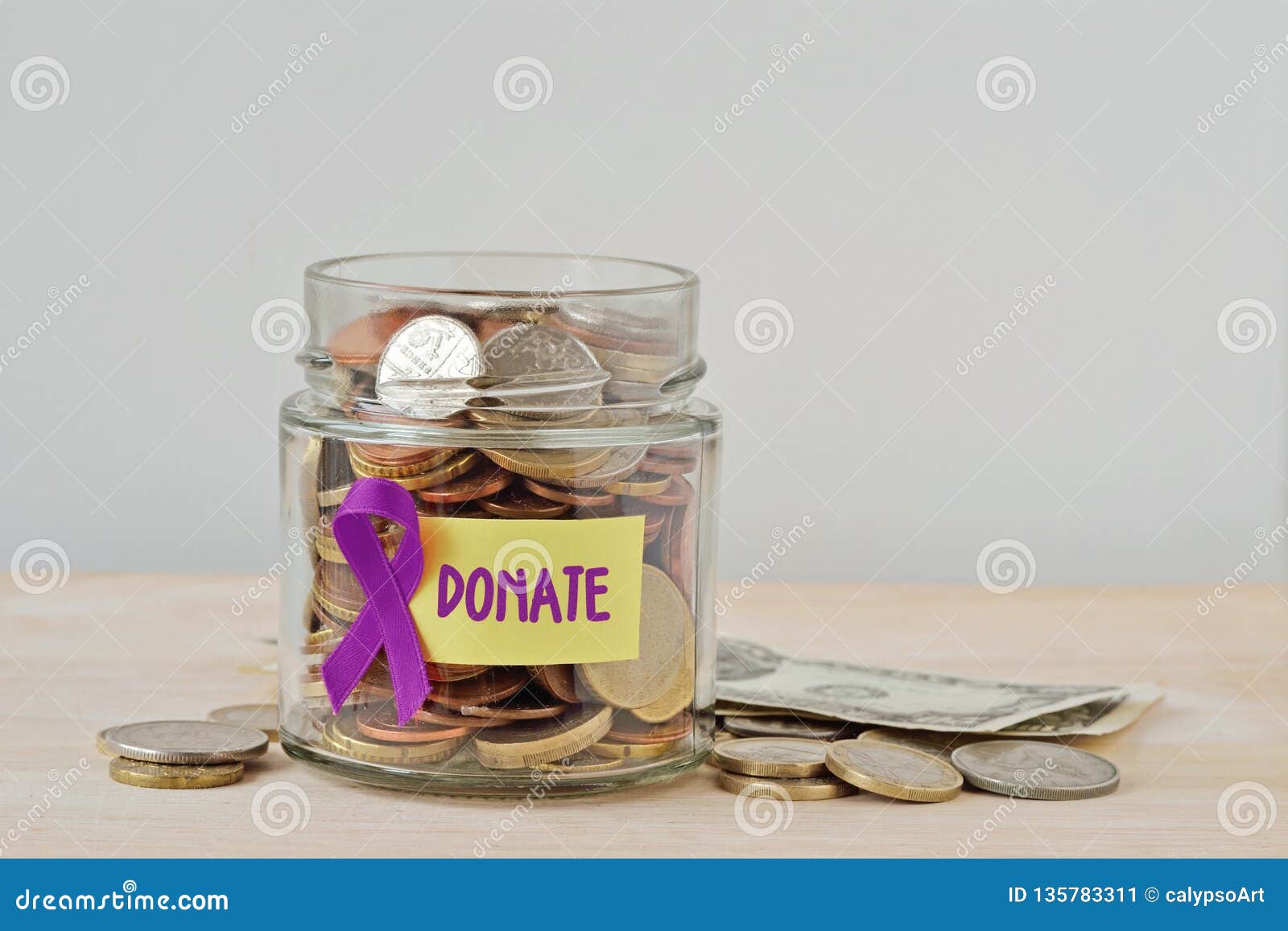 money jar full of coins with violet ribbon and donate label - concept of alzheimer, pancreatic cancer, epilepsy , hodgkin`s