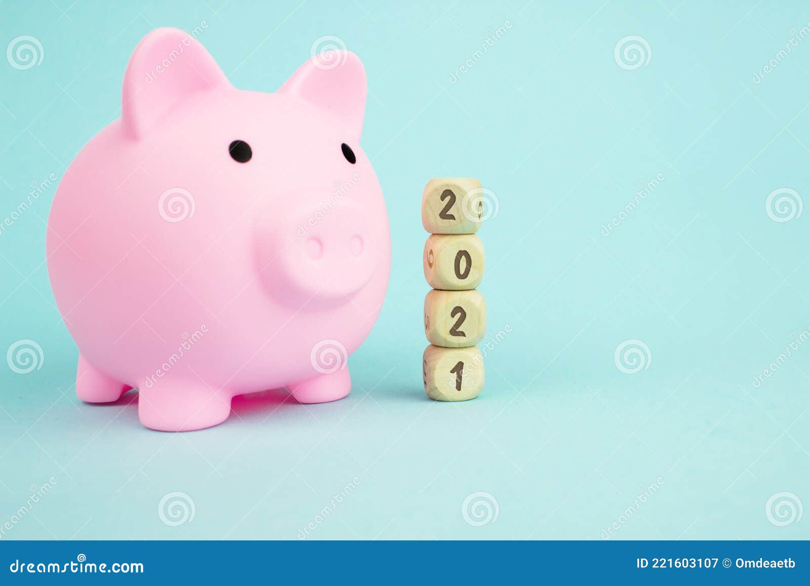 money saving for future investment and retirement concept in 2021 year. pink piggy bank with geometric wood blocks cube adt text