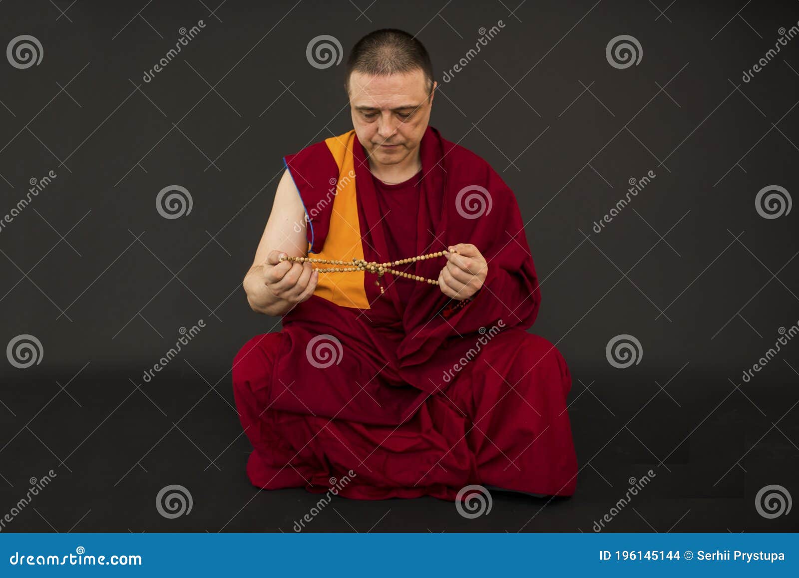 the monk holds the rosary in his hand