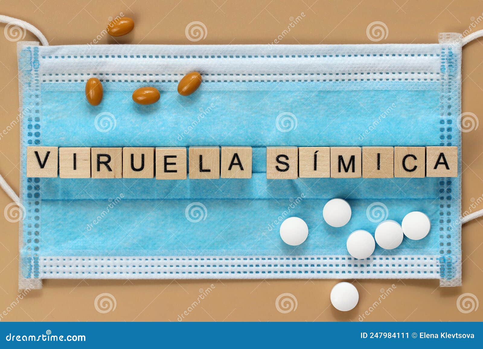 viruela sÃÂ­mica is the name of the monkeypox virus in spanish. the word is laid out with wooden cubes on a surgical face mask.