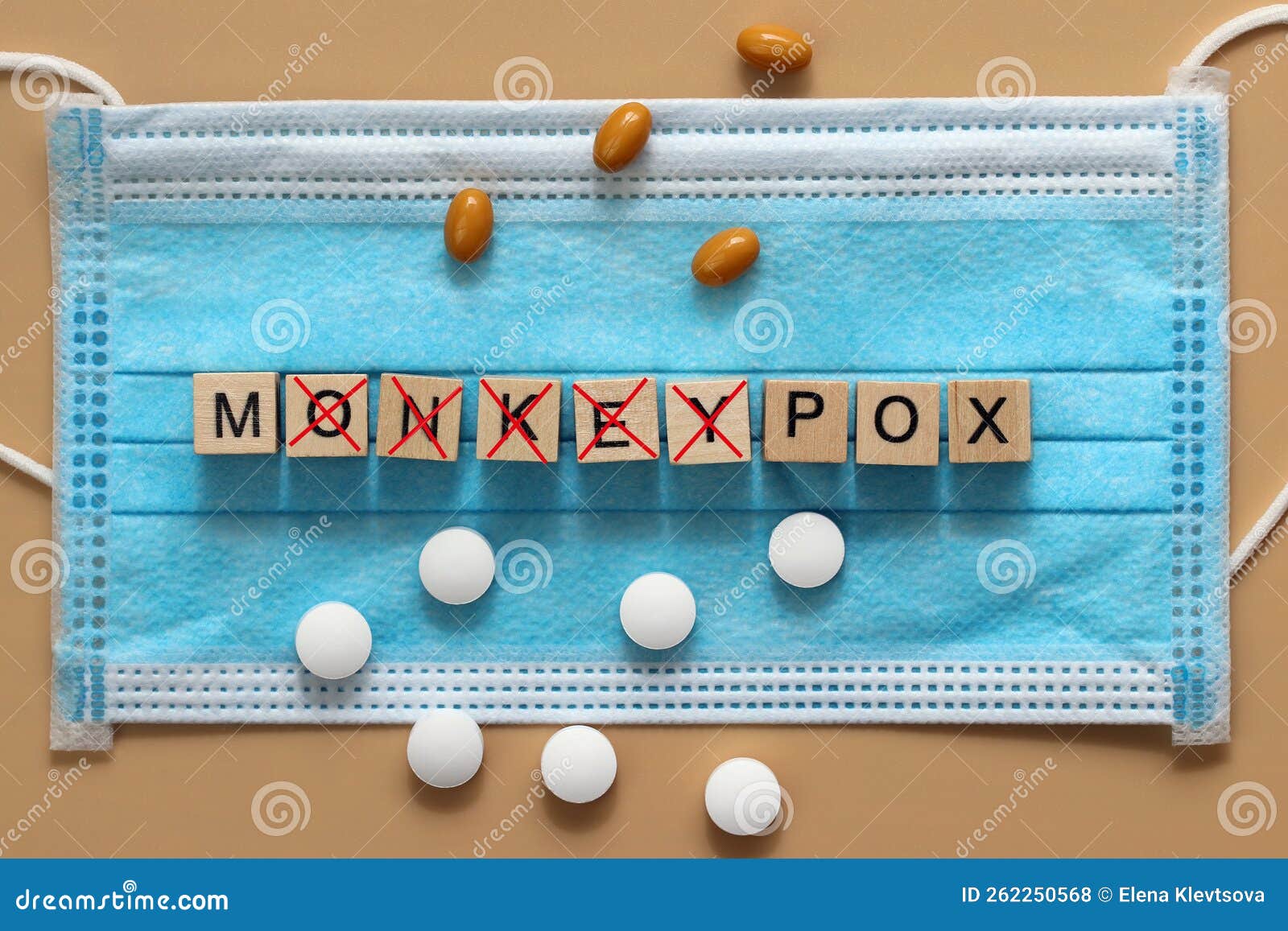 the monkeypox virus is laid out with wooden cubes on a surgical face mask. there are various pills lying around. renaming the