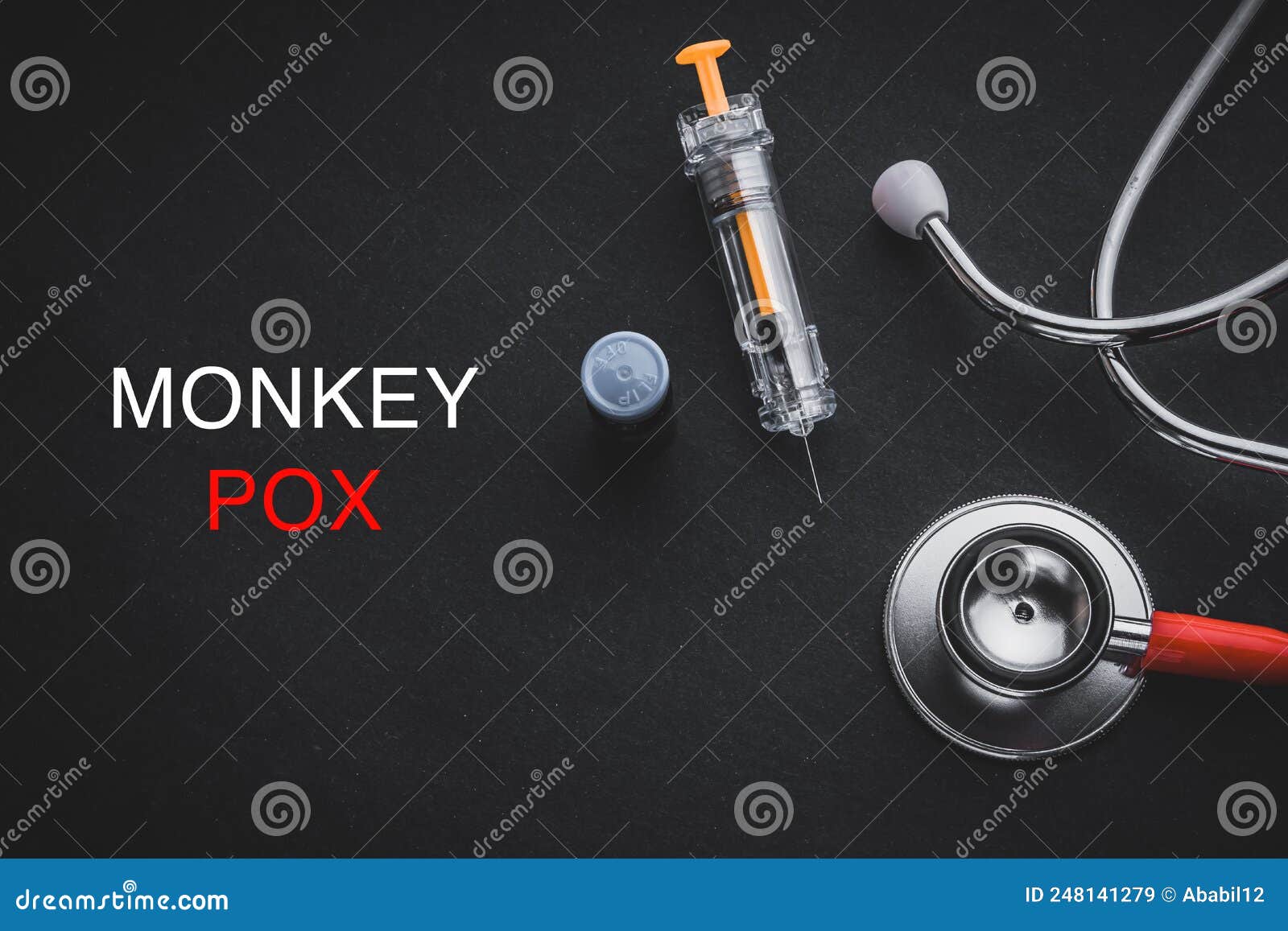 monkeypox words written with stethoscope, syringe and vaccine bottle on black background.