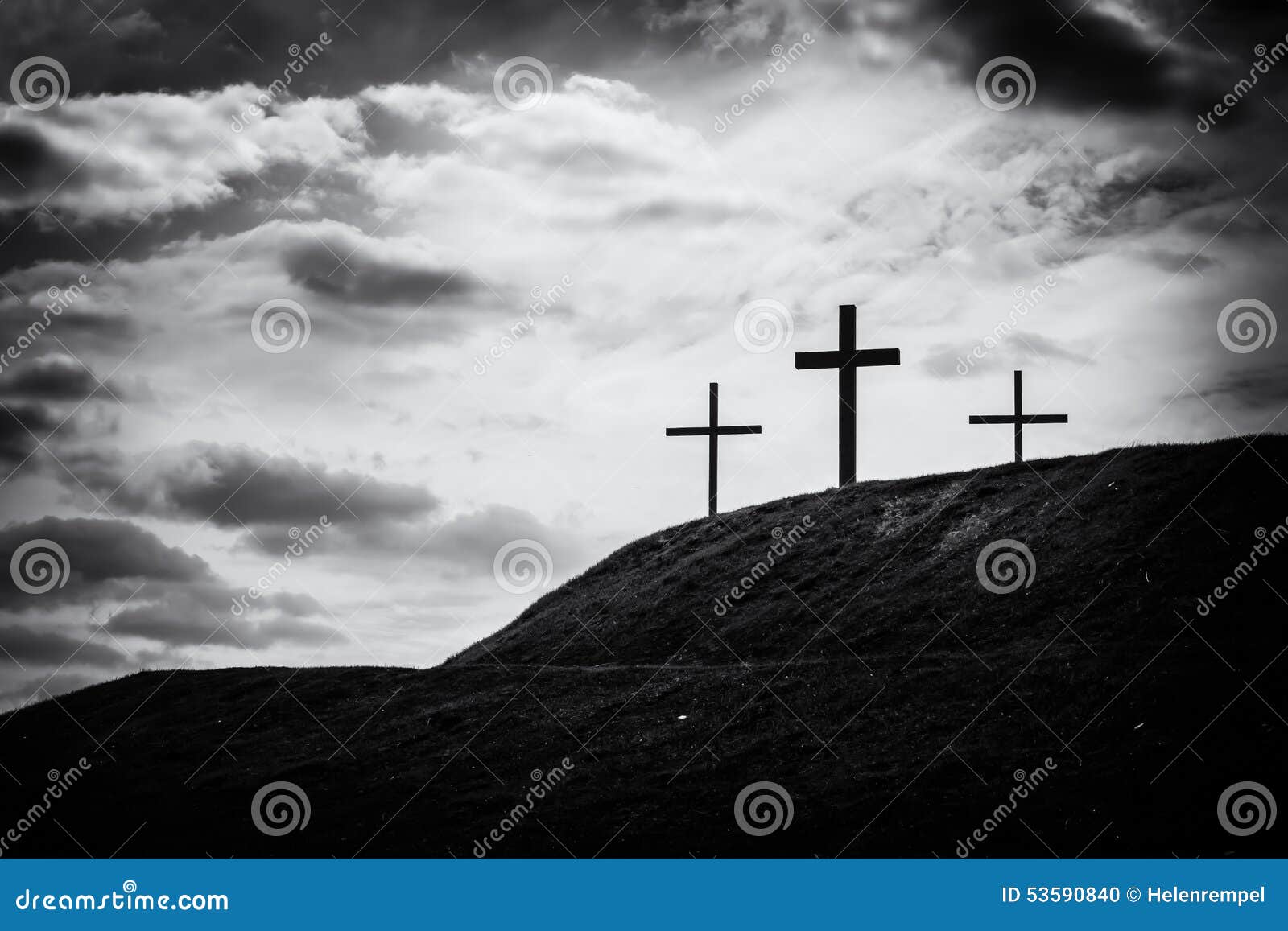 monochrome image of three crosses sitting on a hill