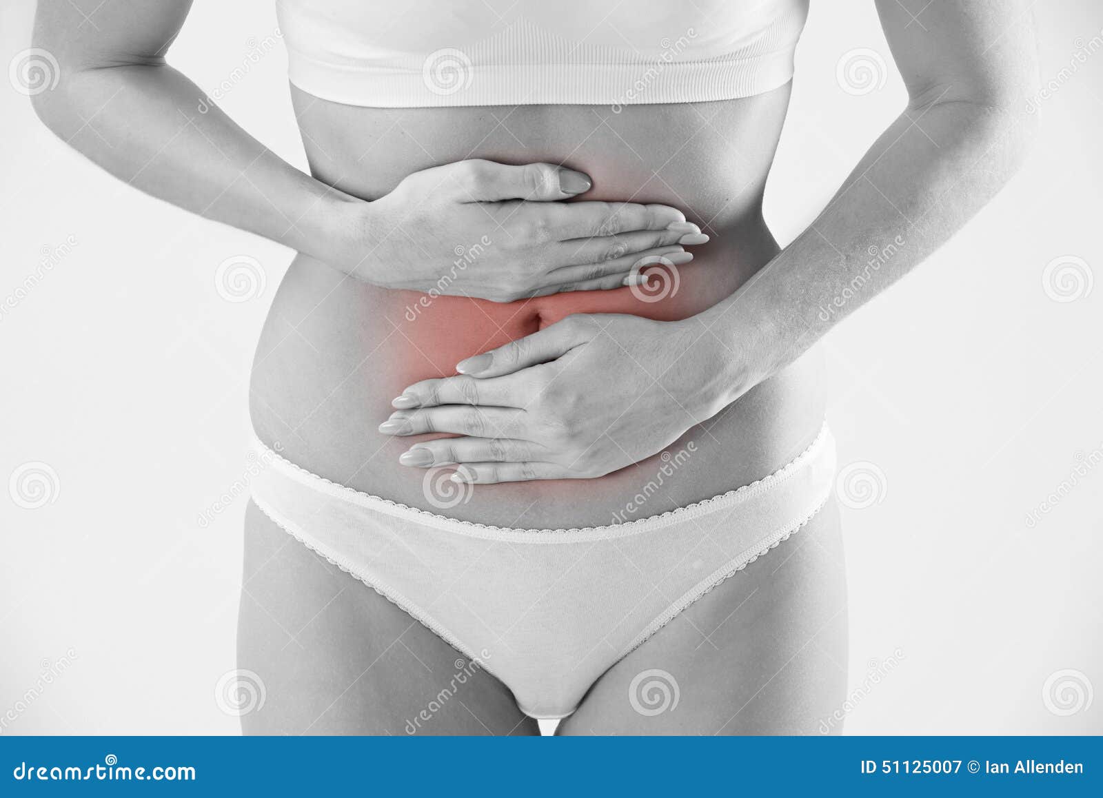 Monochrome Shot of Woman in Underwear Holding Stomach in Pain