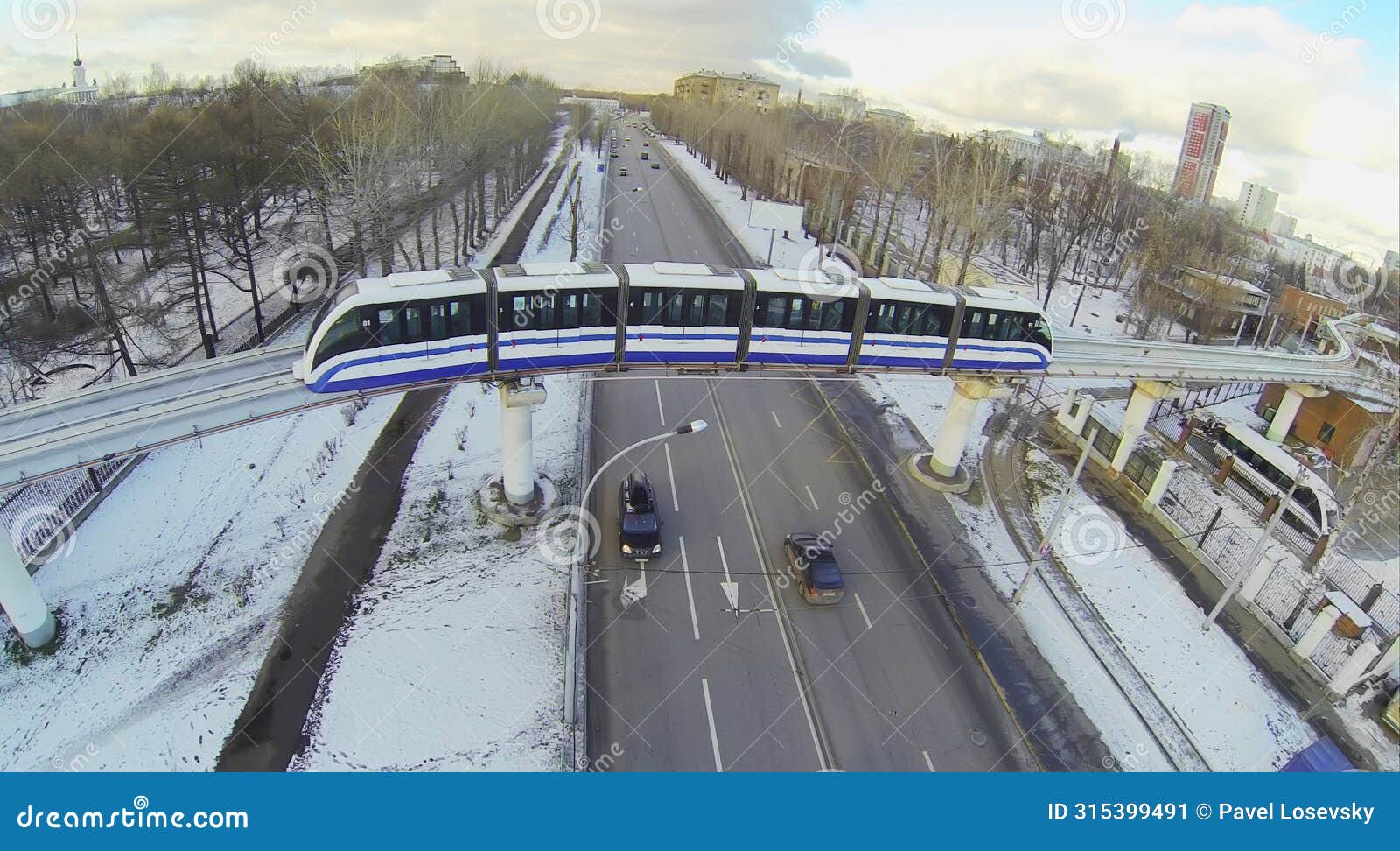 monorail train passes over a four-lane road in the