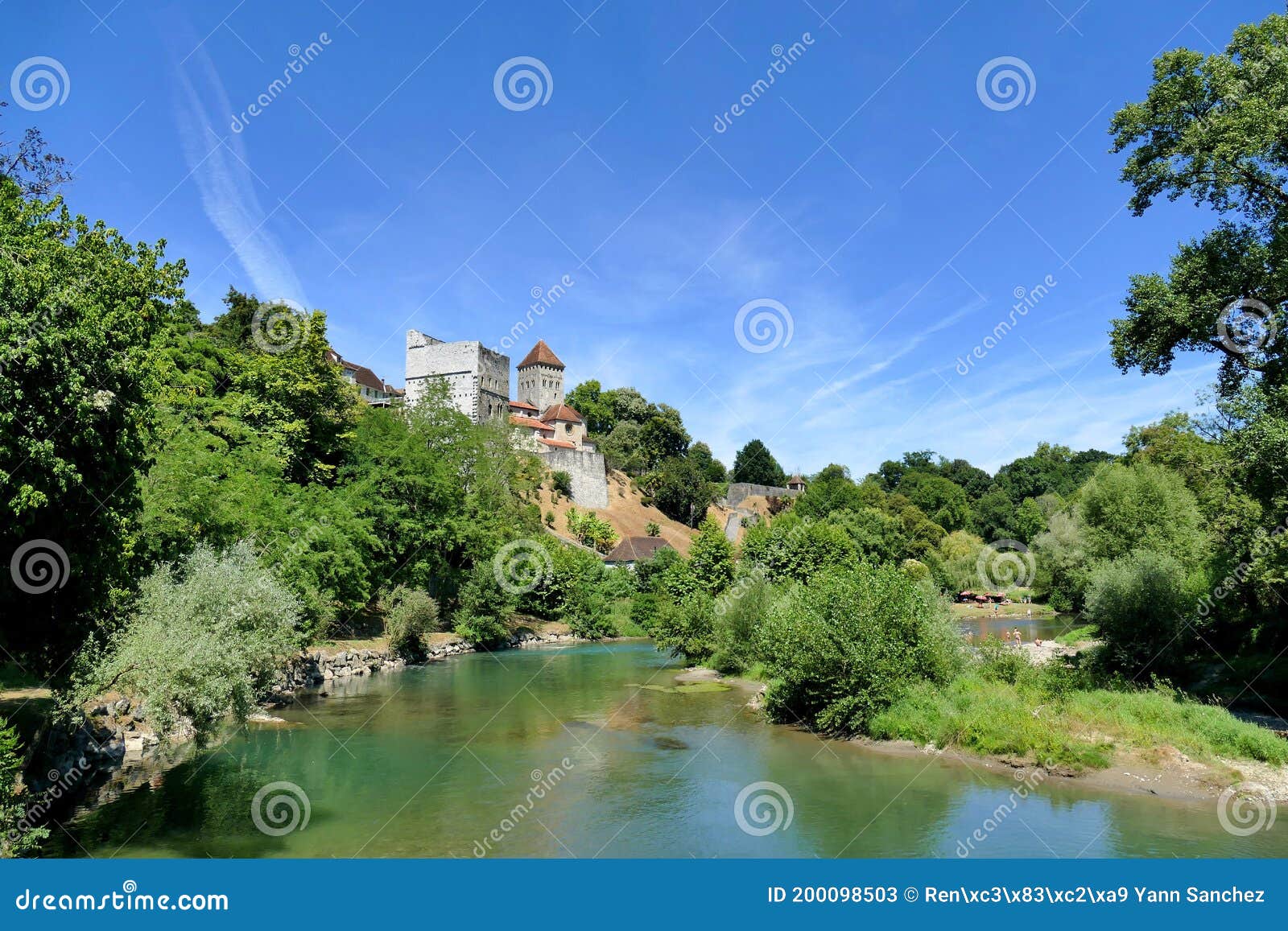 the monrÃÂ©al tower and the saint-andrÃÂ© church in sauveterre-de-bÃÂ©arn overlooking the river gave dÃÂ´oloron