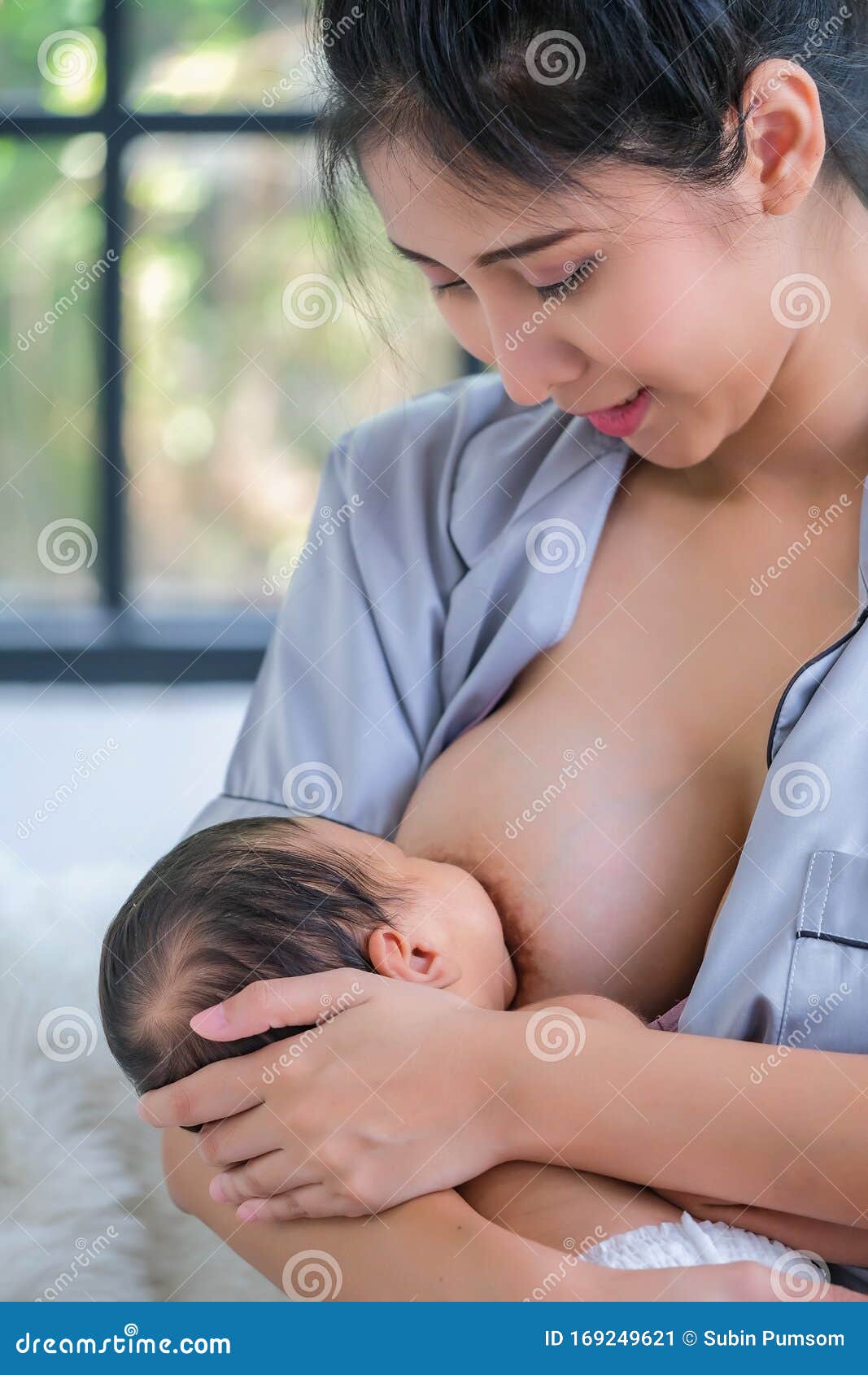 1.5 Month Old Asian Baby is Happy To Suck Breast Milk Stock Image